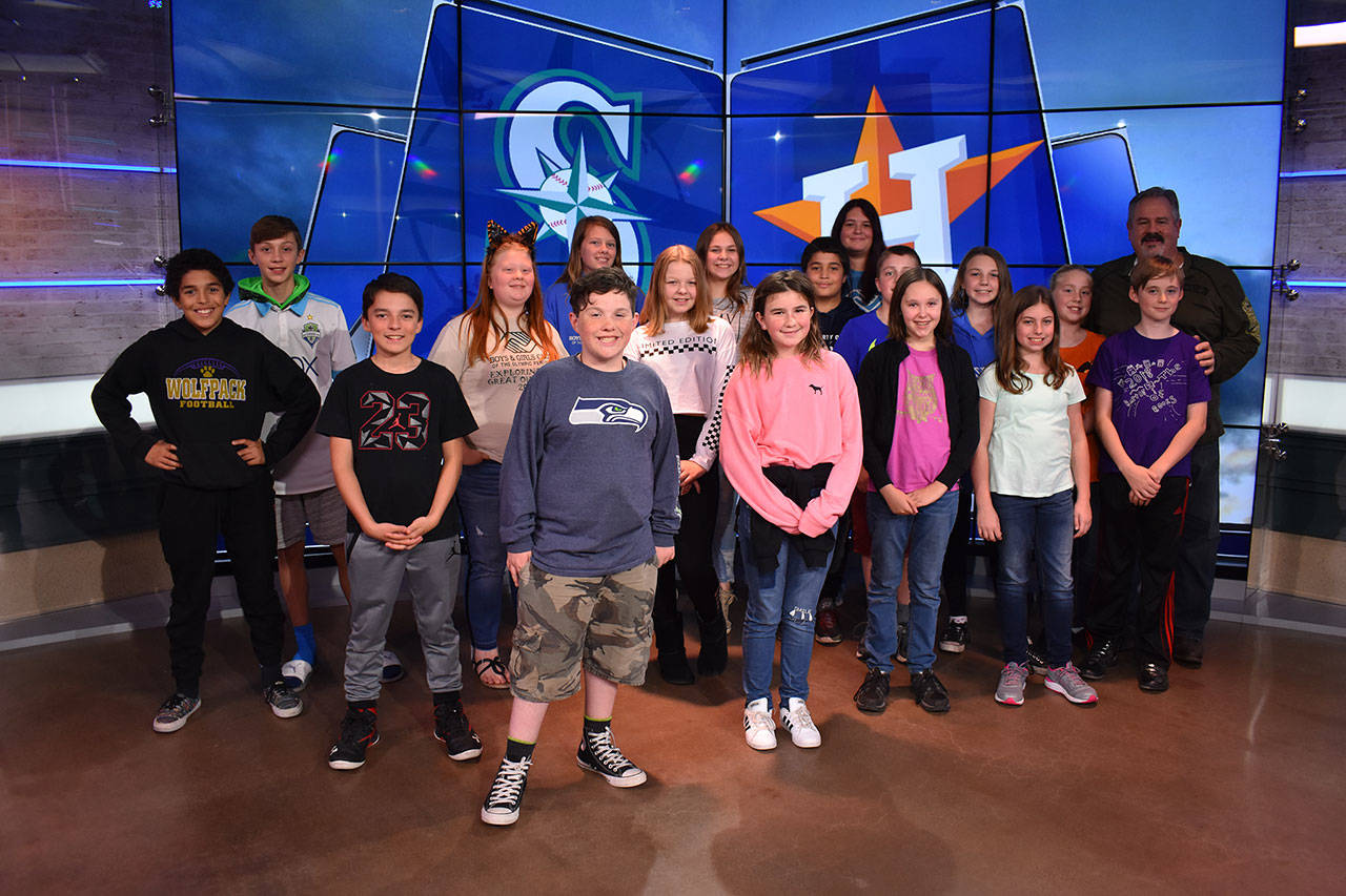 Sixteen middle schoolers with the Sequim Boys & Girls Club and unit director Dave Miller and middle school coordinator Kaylah Garling take a tour of the ROOT SPORTS headquarters on Oct. 18. Miller said the club members all left “flying high.” Photo courtesy of Dave Miller