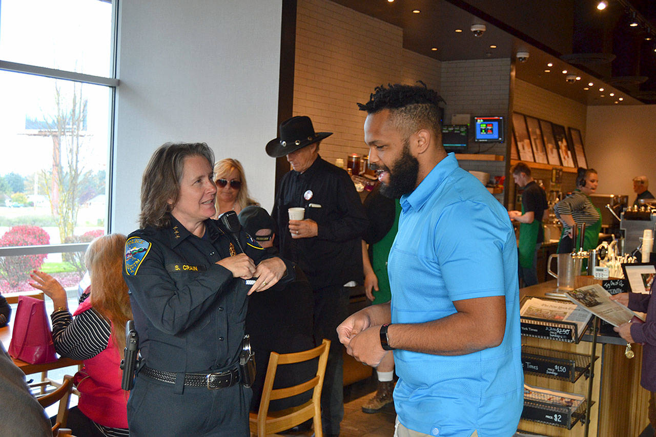 Sequim Police Chief Sheri Crain speaks with Lorenzo Earl, a manager with AT&T, during the Coffee with a Cop meet-and-greet at Starbucks on Oct. 23. Sequim Gazette photo by Matthew Nash