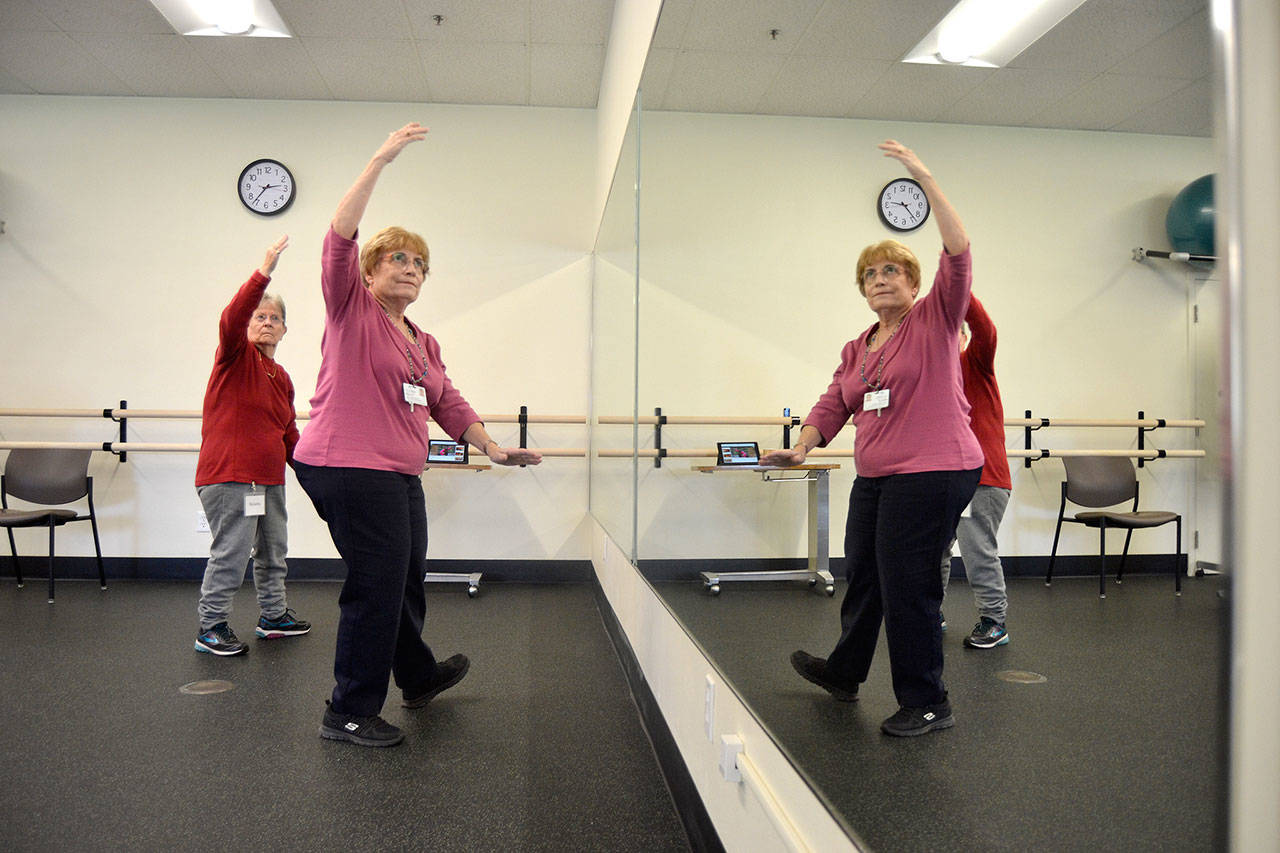 Peggy Scheideler, a physical therapist, on right, leads a class in Tai Ji Quan, including Roberta Prentice in the YMCA of Sequim to help with balance and prevent falls. This was the first class offered through Olympic Medical Center’s partnership with the YMCA for its Wellness Services. Sequim Gazette photo by Matthew Nash