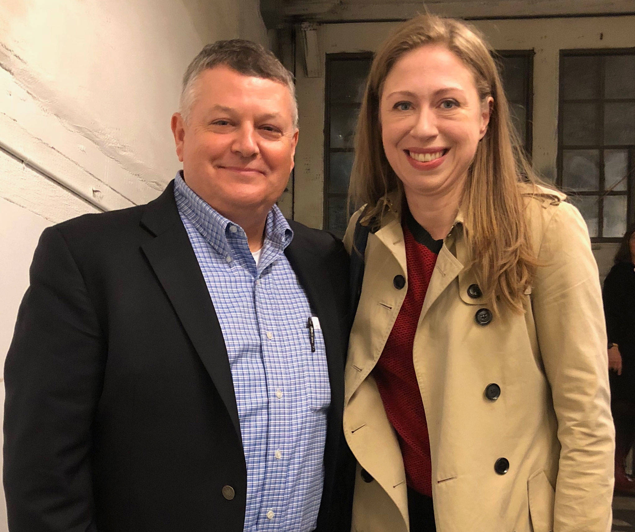 Joe D’Amico, Security Services Northwest Inc. president, left, stands with Chelsea Clinton on Oct. 24 after she attended a book signing event in Seattle. Security Services was contracted to provide a security detail for Clinton’s book signing event. Submitted photo