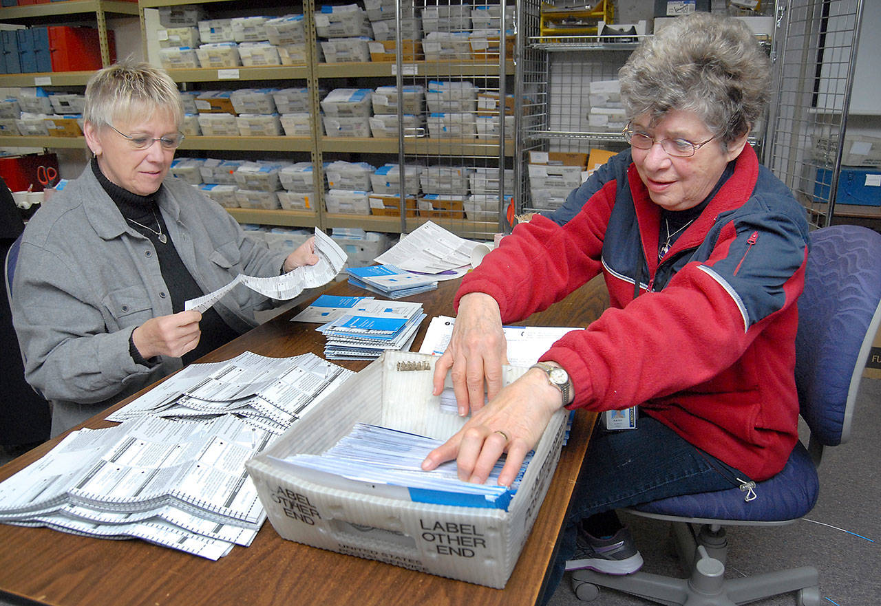 Election workers Debbie Cain, left, and Kathy Schreiner, both of Sequim, sort through untabulated ballots Friday at the Clallam County Courthouse in Port Angeles. (Keith Thorpe/Peninsula Daily News)