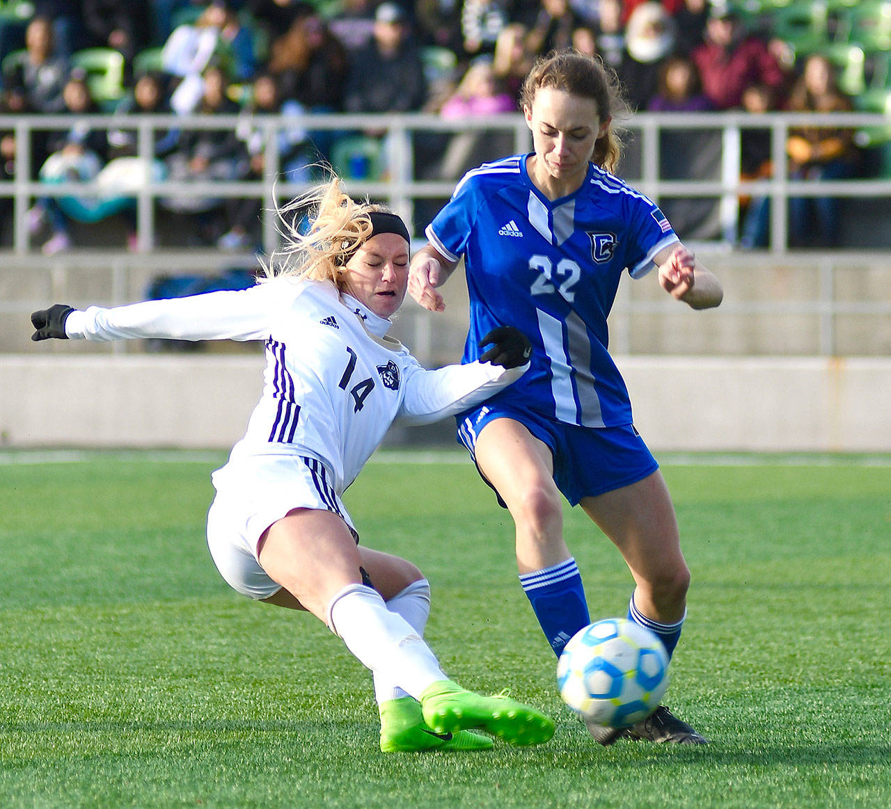Peninsula Taylor Graham battles for a loose ball with Clark’s Julie Williams in the NWAC championship match in Tukwila Sunday. The Peninsula women won 2-0 to win the NWAC championship. Photo by Jay Cline