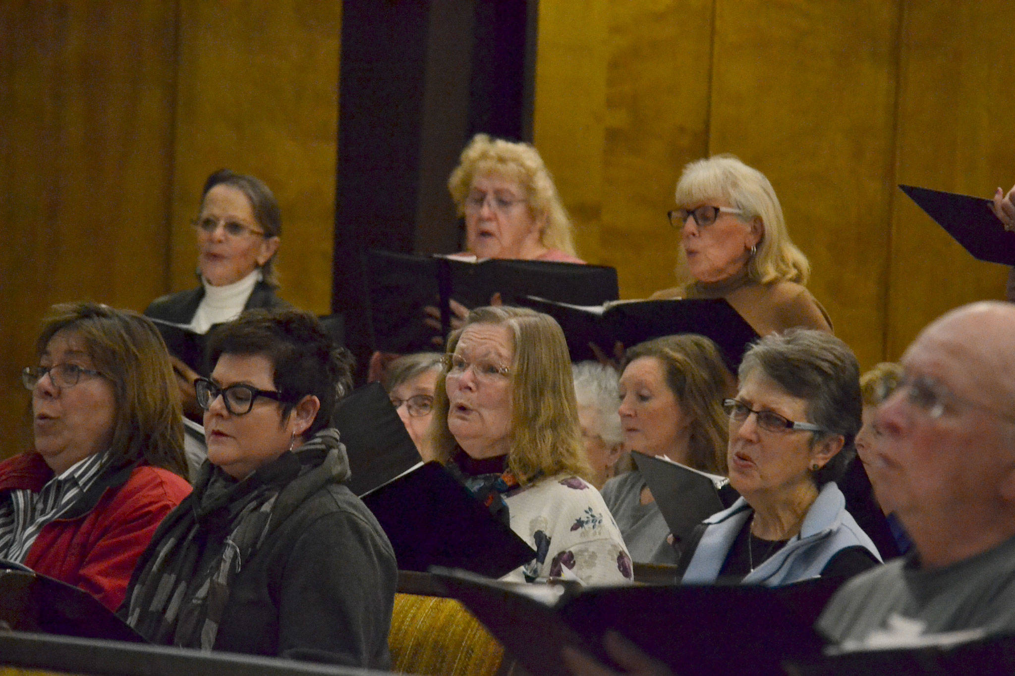 Kyra Humphrey, center, helped recruit the Sequim Community Christmas Chorus’ new director Louise Pluymen following the move of long-time director Gary McRoberts. Humphrey said she and Pluymen went to college together and that she’ll help nurture each singer. Sequim Gazette photo by Matthew Nash