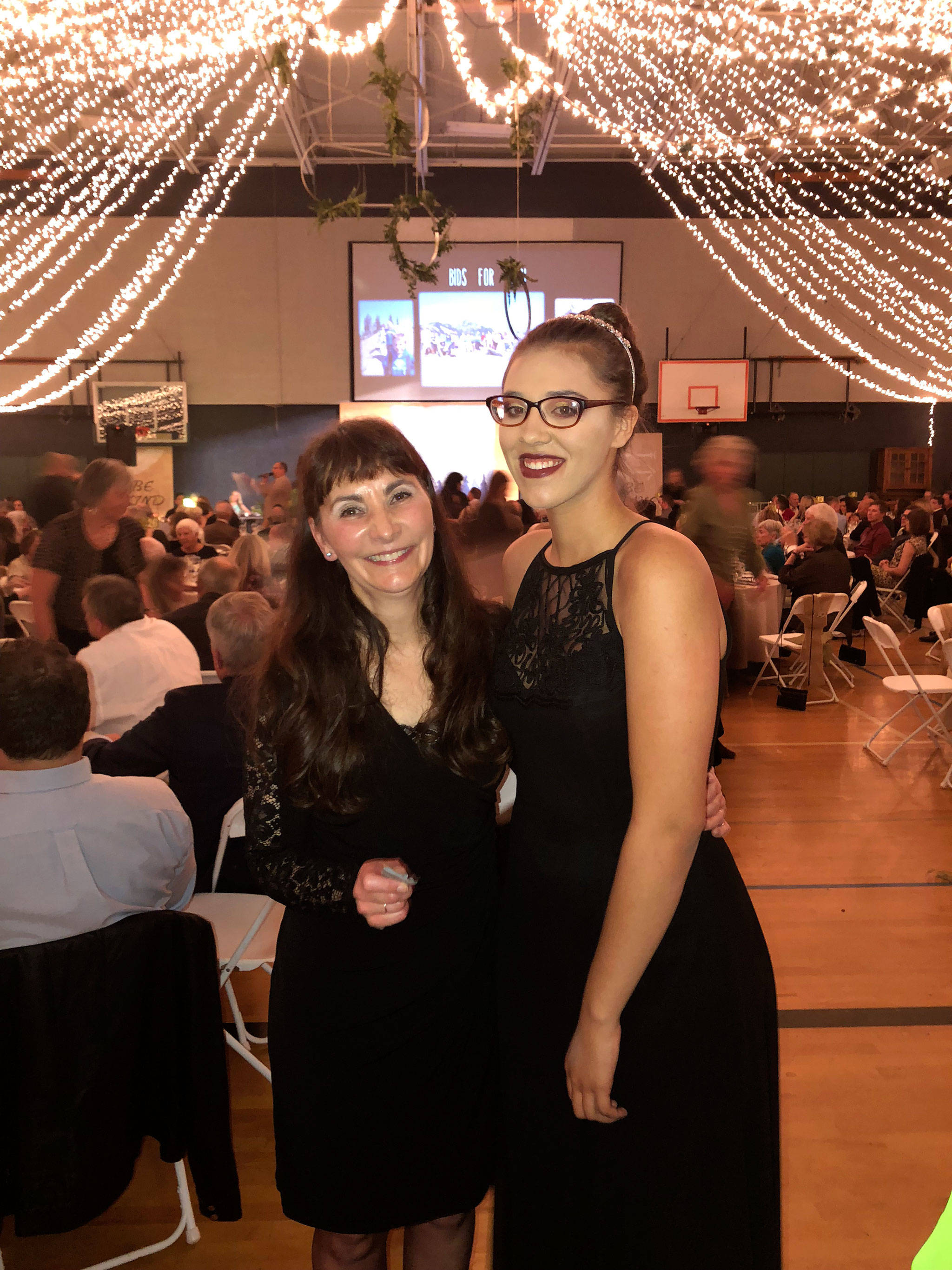 Mary Budke, executive director of the Boys & Girls Clubs of the Olympic Peninsula, stands with 15-year-old Pursha True of the Port Angeles club on Nov. 10 during the clubs’ 30th auction. The clubs raised a record $326,000 for operations. Photo courtesy of Boys & Girls Clubs of the Olympic Peninsula