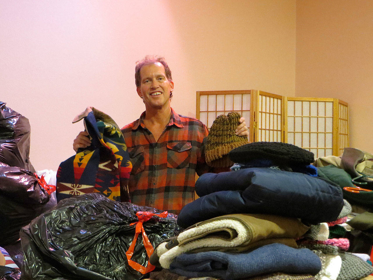 Steve Ford, co-owner of Drennan & Ford Funeral Home and Crematory, displays the hundreds of pieces of cold-weather clothing donated by Clallam County residents as part of the Drennan & Ford Funeral Home’s recent “Sweaters for Veterans” collection drive. The cold weather clothing will be distributed by “Voices for Veterans” and local veteran groups to area veterans in need of such clothing during the winter months. This is the firm’s ninth year organizing this project, part of its many annual and ongoing projects to assist veterans and active duty service personnel. For more information about “Sweaters for Veterans,” call 360-457-1210 or email to steve@drennanford.com. Submitted photo