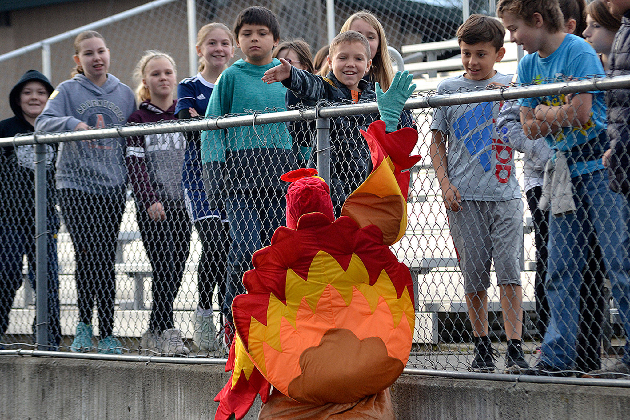 Principal Becky Stanton high fives fifth-grader Ryan Spelker and other students as they prepare for Helen Haller Elementary’s Turkey Trot. Sequim Gazette photo by Matthew Nash