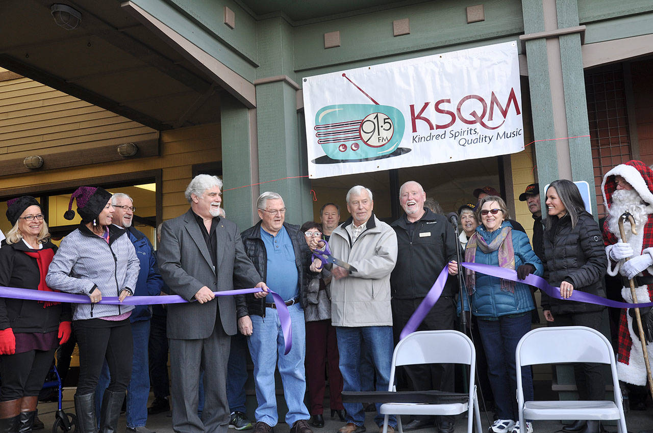 Rick Perry, KSQM 91.5 FM founder, cuts the ribbon on the station’s new facility at 609 W. Washington St. on Dec. 7. He’s surrounded by community members and dignitaries, including, Jeff Bankston, KSQM program director, Bob Sampson,KSQM’s first chief engineer, George Dooley, president of Sequim Community broadcasting, and Sequim Deputy Mayor Candace Pratt. Sequim Gazette photo by Matthew Nash