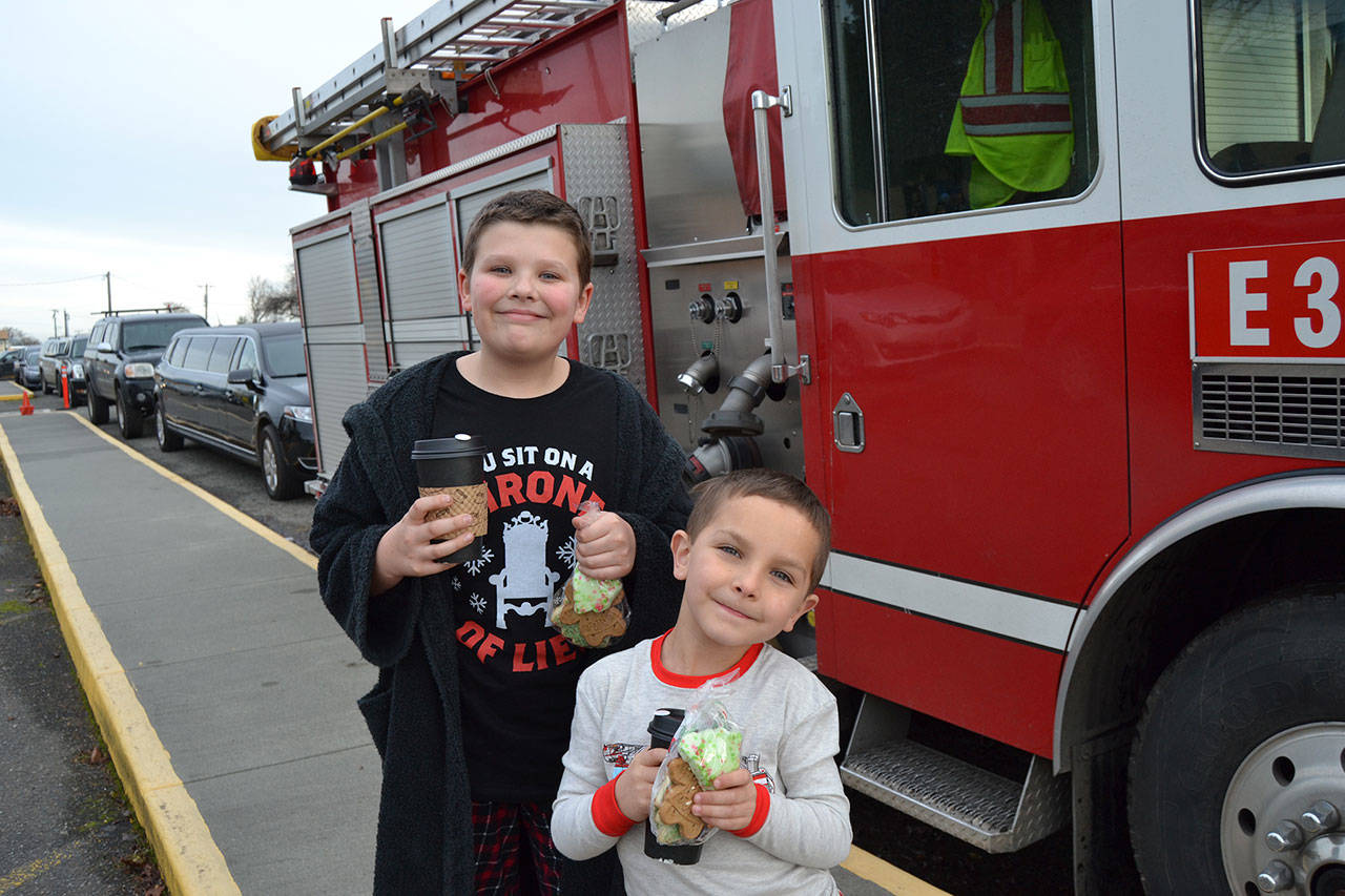 Helen Haller students Alex Kruckeberg, left, and Marcus Sheldon ready for rides home in a limo and a fire truck on Dec. 21 as a reward for earning the most for the school’s Turkey Trot in November. Sequim Gazette photo by Matthew Nash