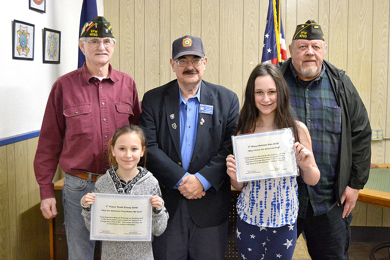 On Jan. 8, leaders with Sequim VFW Post 4760, from top left, John Dowd, chaplain, Bob Wasserman, president Post 4760 Auxiliary, and Steve Henriksen, quartermaster, recognized sisters Makaila, left, and Miranda Marihugh for winning the post’s essay contests for grades 3-5 and 6-8. Makaila also won the Olympic Peninsula’s District 14 contest to move on to state. Sequim Gazette photo by Matthew Nash