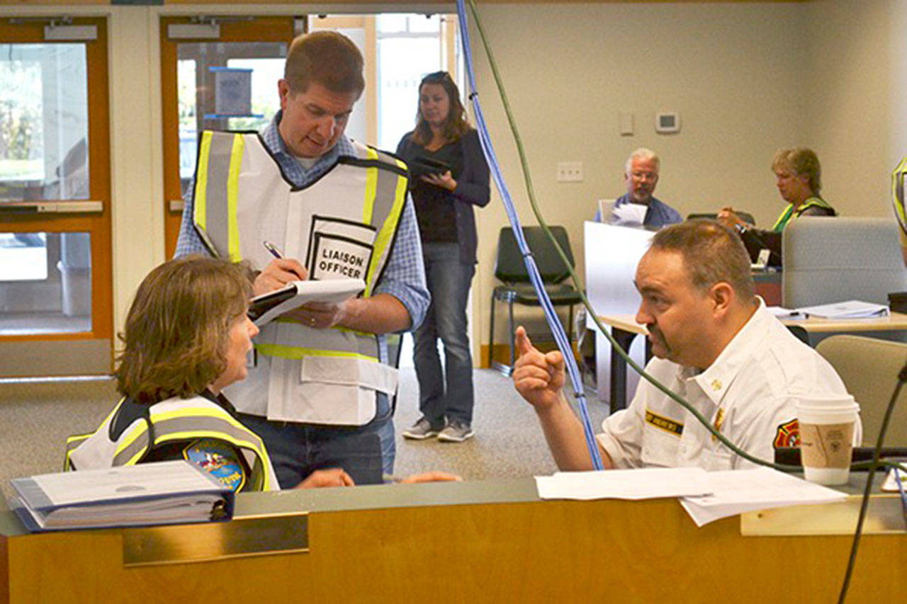A new agreement between the City of Sequim and Clallam County Fire District 3 allows for more joint emergency training and job sharing during an incident at the Emergency Operations Center in the Sequim Transit Center, seen here in June 2016 with Sequim City Manager Charlie Bush, Sequim Police Chief Sheri Crain and Fire Chief Ben Andrews. Sequim Gazette file photo by Matthew Nash
