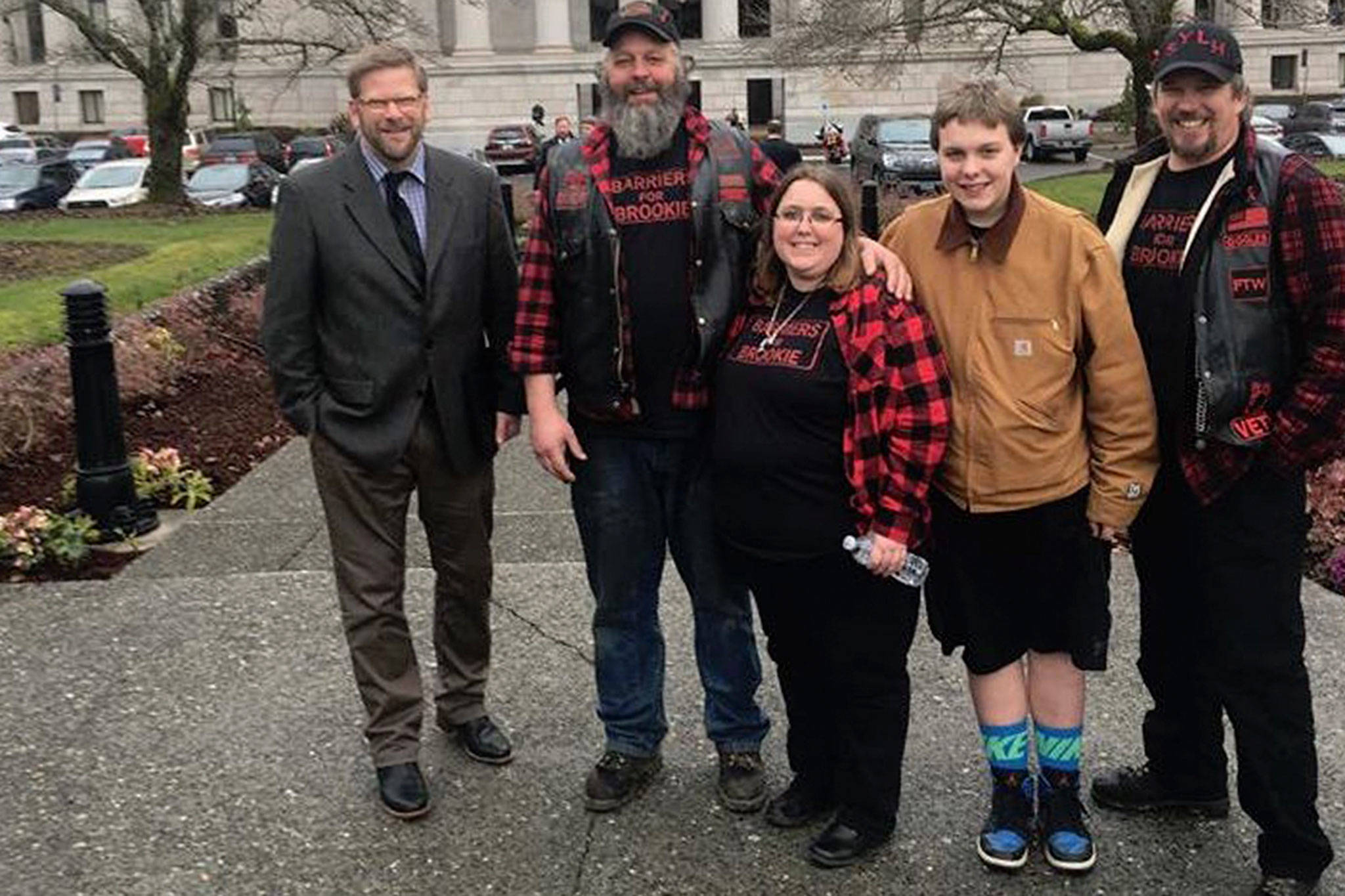 State Representative Mike Chapman, left, stands with the Bedinger family, including Don Bedinger, Kim Bedinger, Chase Bedinger, and James Kirkpatrick in Olympia. The Bedinger family asks community members to send letters of support to Chapman for improvements to the Morse Creek curve east of Port Angeles as he proposes a $5 million budget proviso to the 2019-21 state spending plan. Photo courtesy of the Bedinger family