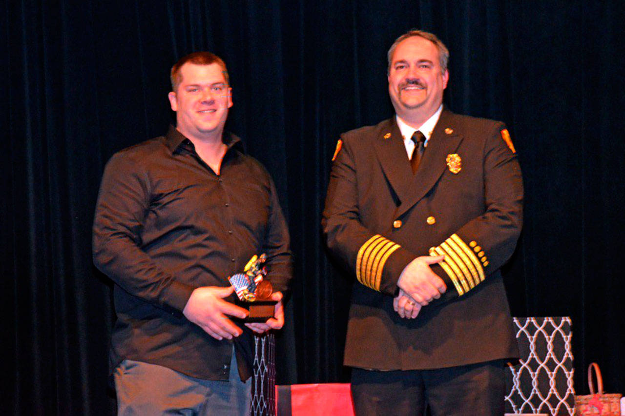 Travis Anderson received the Career Firefighter of the Year award in January from Fire Chief Ben Andrews. He was selected by a committee of peers after nominations for his accomplishments. Photo courtesy of Clallam County Fire District 3