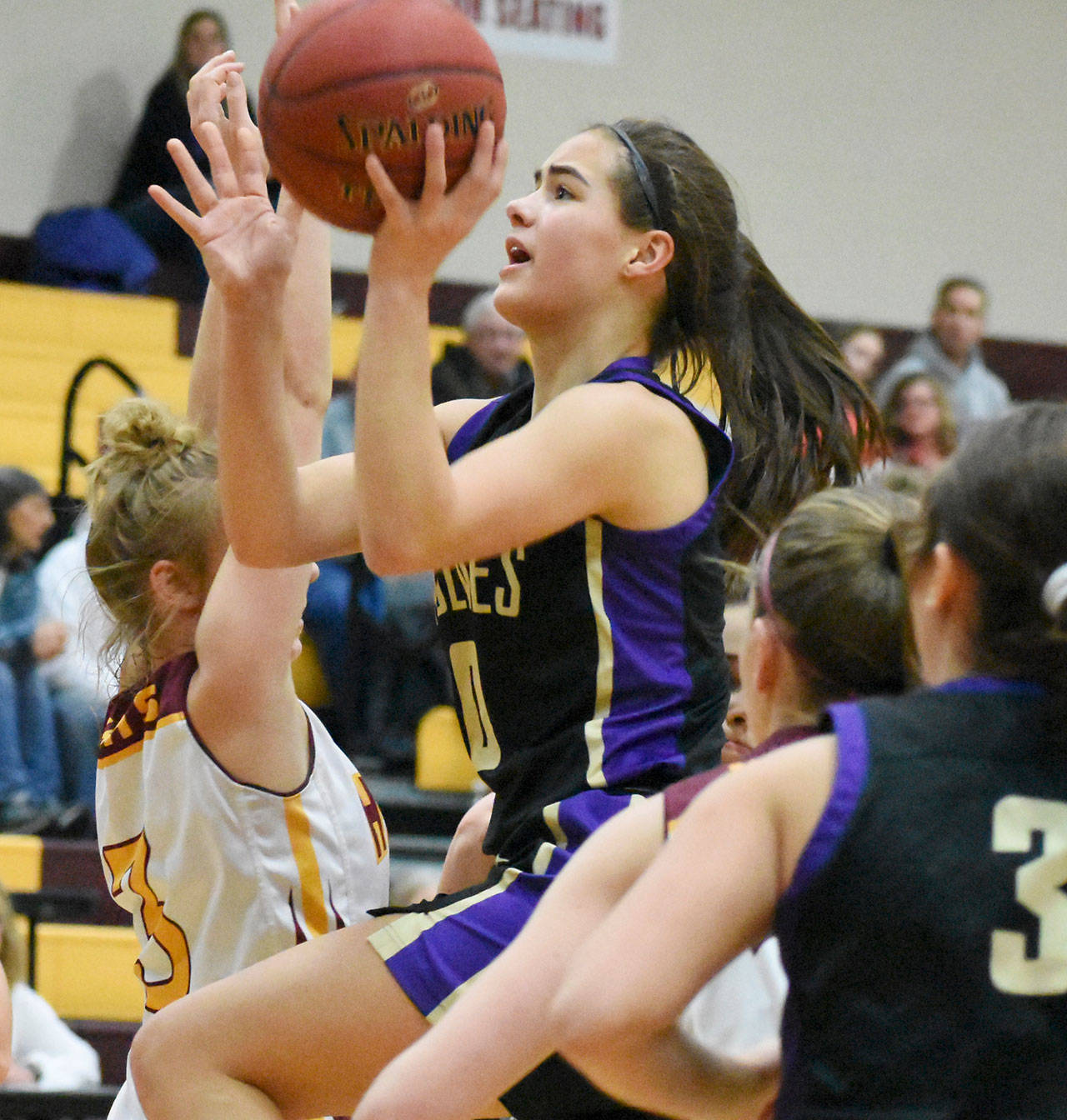 Sequim’s Hope Glasser drives to the basket in a West Central District playoff game Feb. 14 against top-seeded White River. The Hornets topped Glasser’s Wolves, 57-40. Photo by Kevin Hanson/The Courier Herald (Enumclaw)