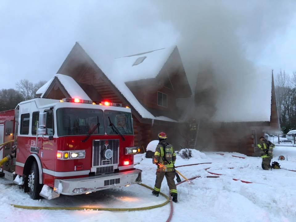 A chimney fire started late Tuesday afternoon on the 1800 block of West Washington Street in a log home. Fire officials with Clallam County Fire District 3 say the fire started on accident near the roof and chimney. Photo courtesy of Clallam County Fire District 3
