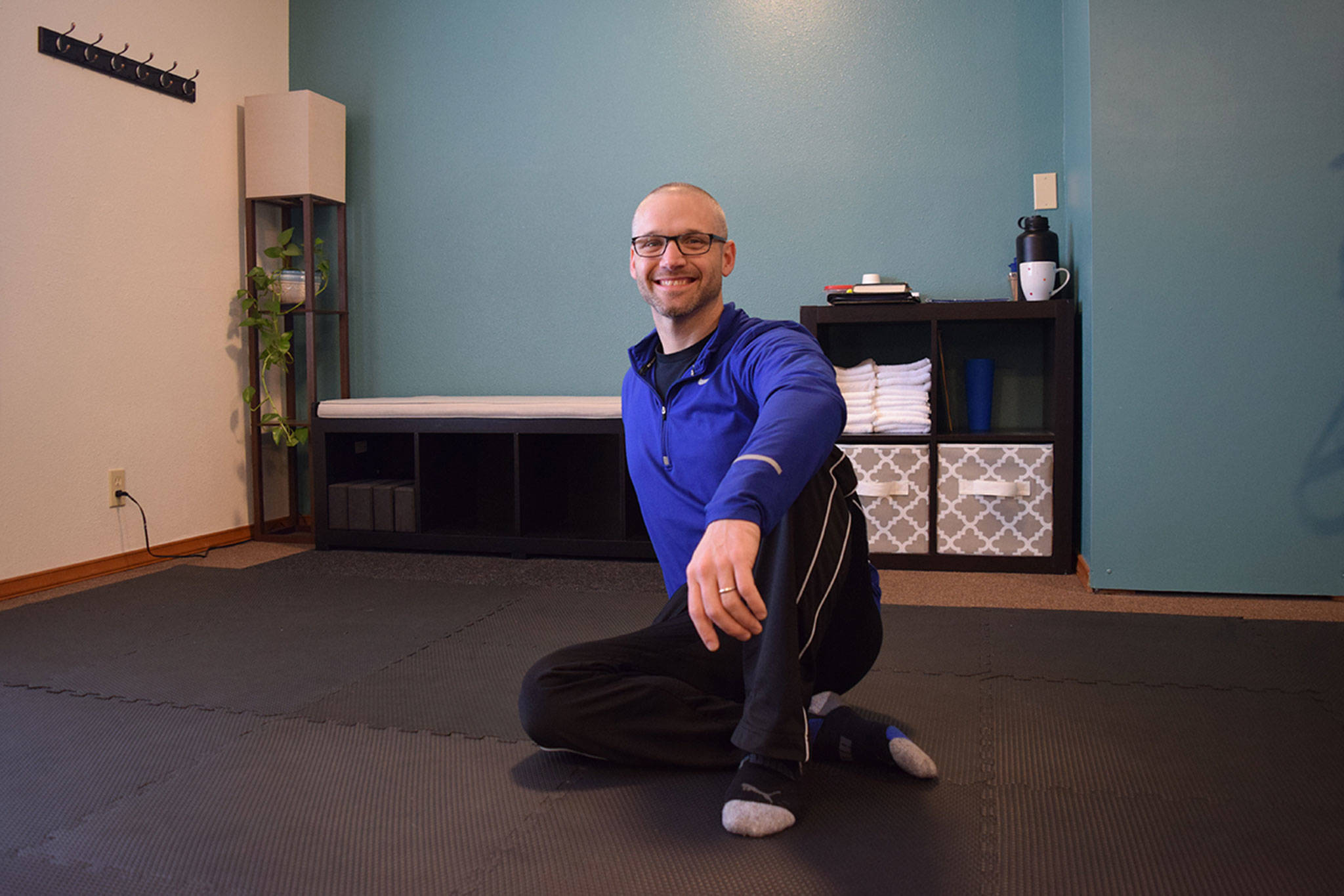 Northwest Fitness LLC owner Kevin Pedrey sits on the mats in his new studio where he offers several programs that focus on pain management, injury screening, movement and self-care. Sequim Gazette photo by Erin Hawkins
