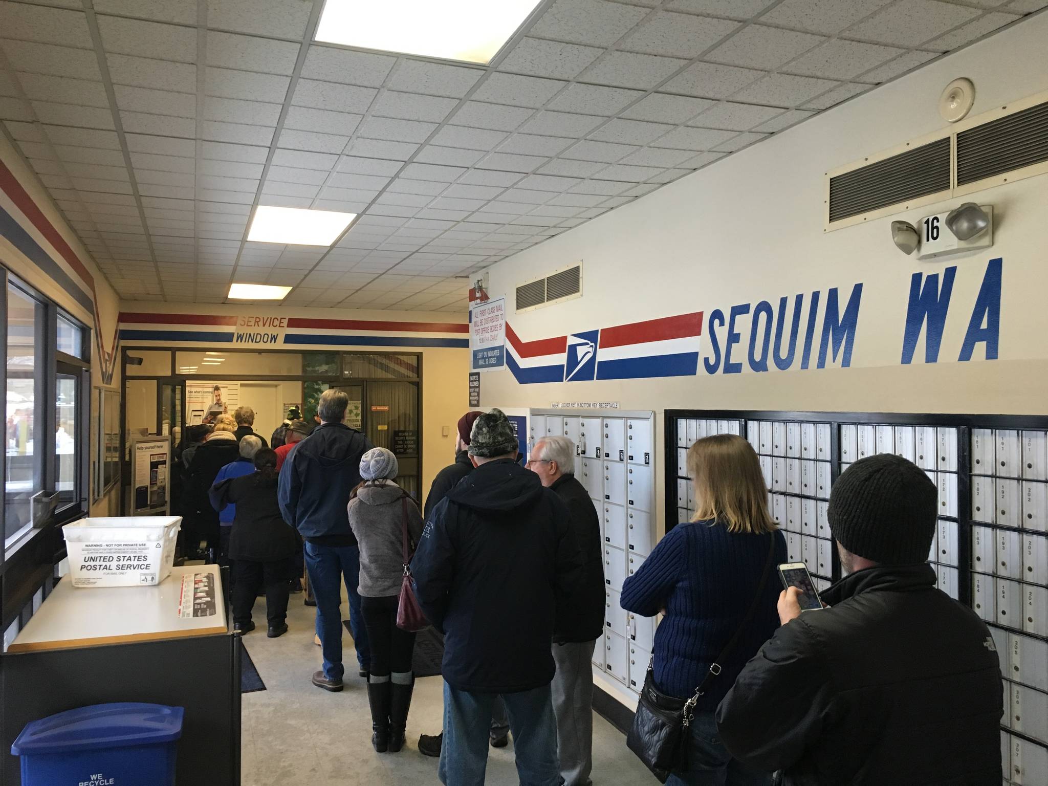 Sequim residents await a long line for their mail last week inside the Sequim Post Office as snow prevented mail carriers from delivering packages and other items to harder-to-reach areas. Sequim Gazette photo by Matthew Nash