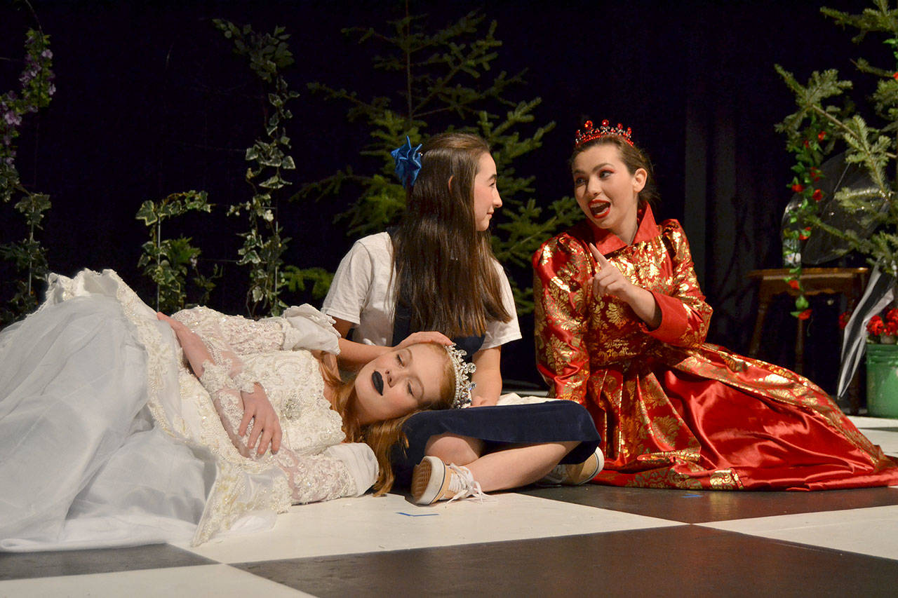 Alice (Kariya Johnson) converses with the Red Queen (Maggie van Dyken) just before the two queens (including White Queen Emily Bundy) opt to take a nap on her in “Through the Looking-Glass.” Sequim Gazette photo by Matthew Nash