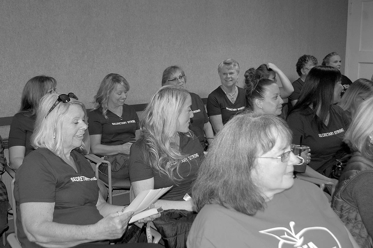 Sequim schools secretaries wear purple shirts that read “secretary strong” at a board meeting last summer where they rallied for higher pay with teachers and classified staff during contract negotiations with the district. Sequim Gazette file photo by Erin Hawkins