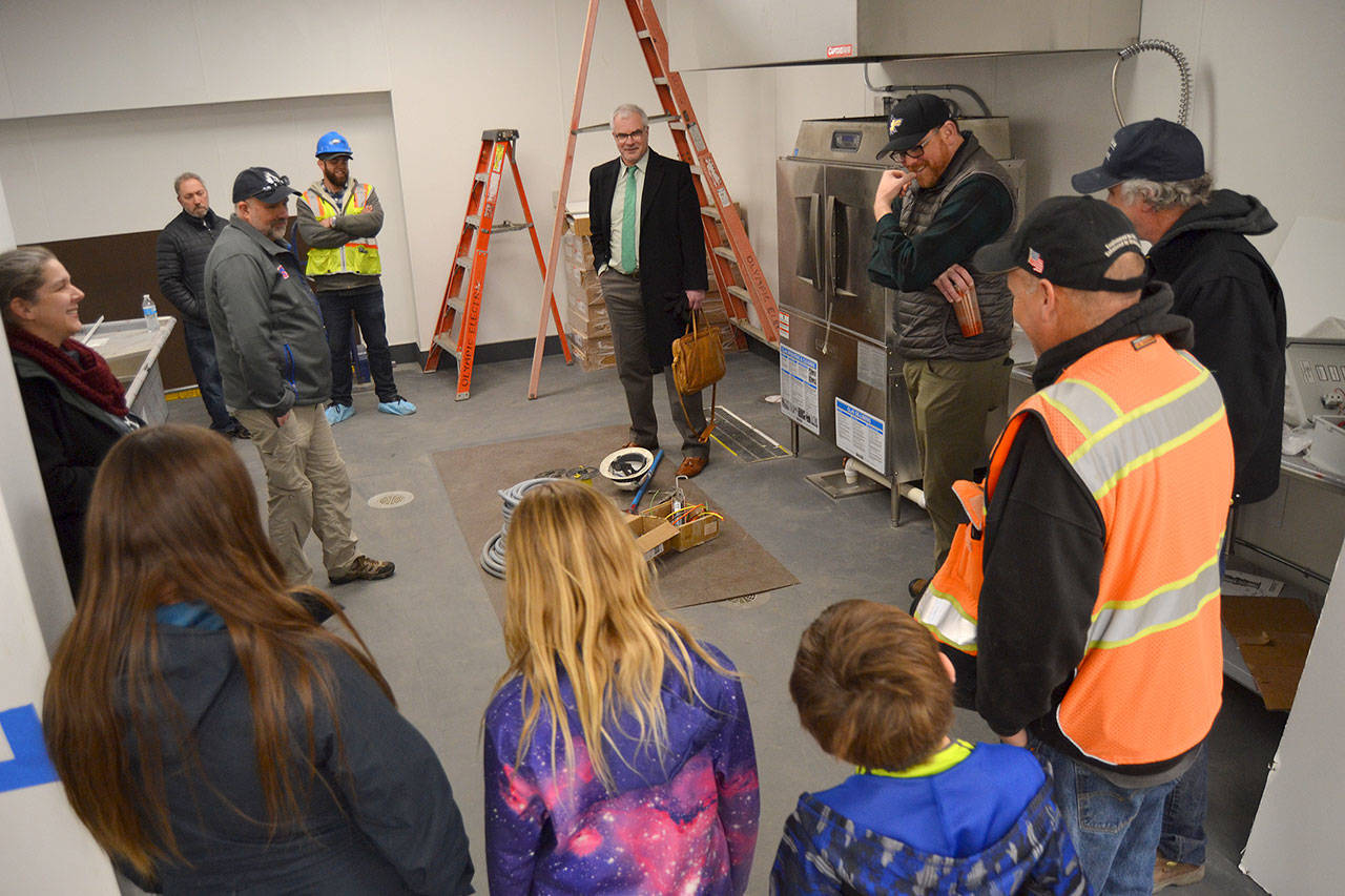 Construction officials, Sequim School District staff and school board members and their family tour the inside of the district’s new central kitchen this week as it’s being readied for a tentative opening in early April to serve 900-plus meals daily. Sequim Gazette photo by Matthew Nash