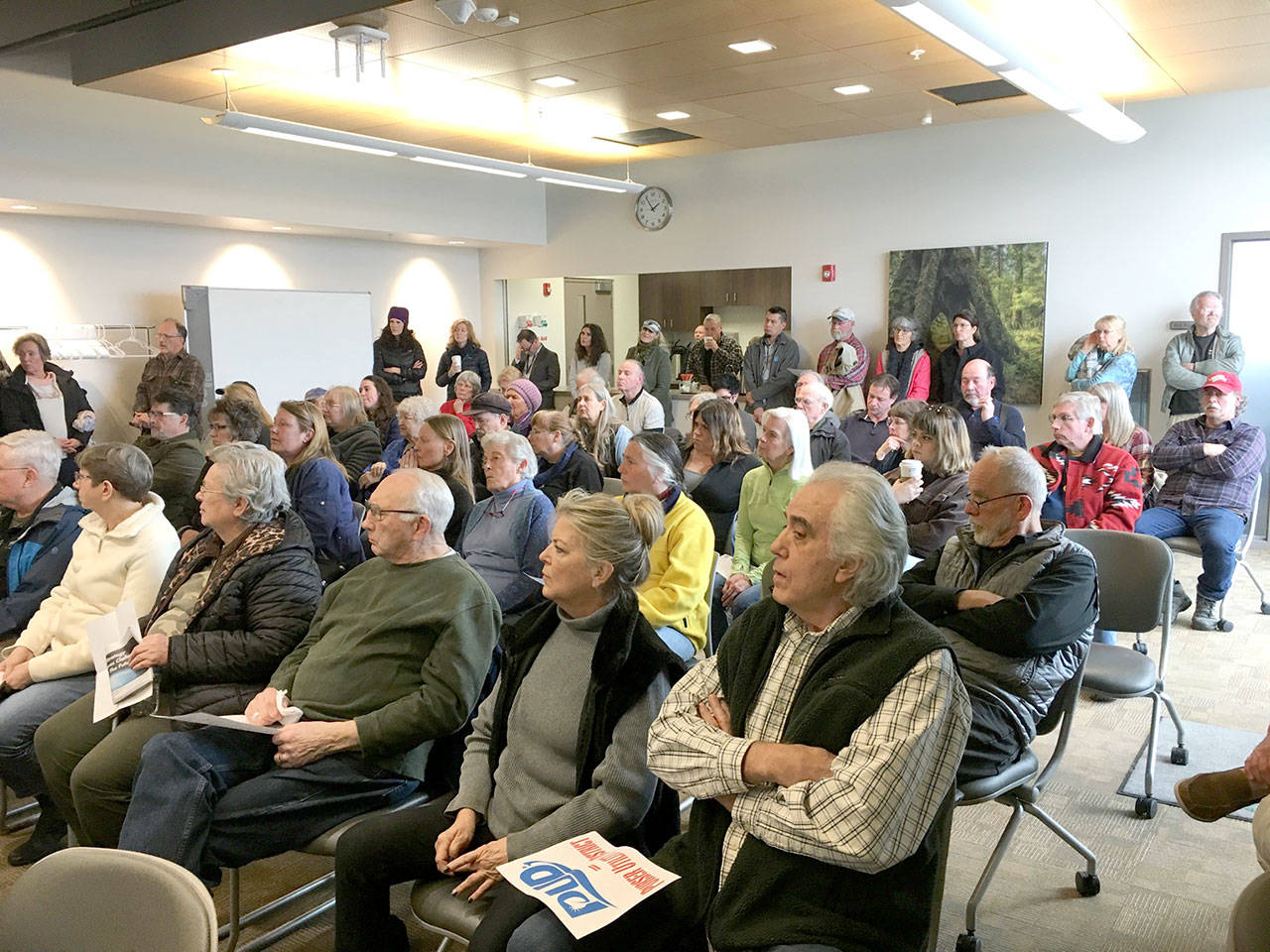 Audience members listen to a discussion on the Clallam County Public Utility District’s residential meter policy at the PUD headquarters in Carlsborg on March 11. Photo by Rob Ollikainen/Peninsula Daily News