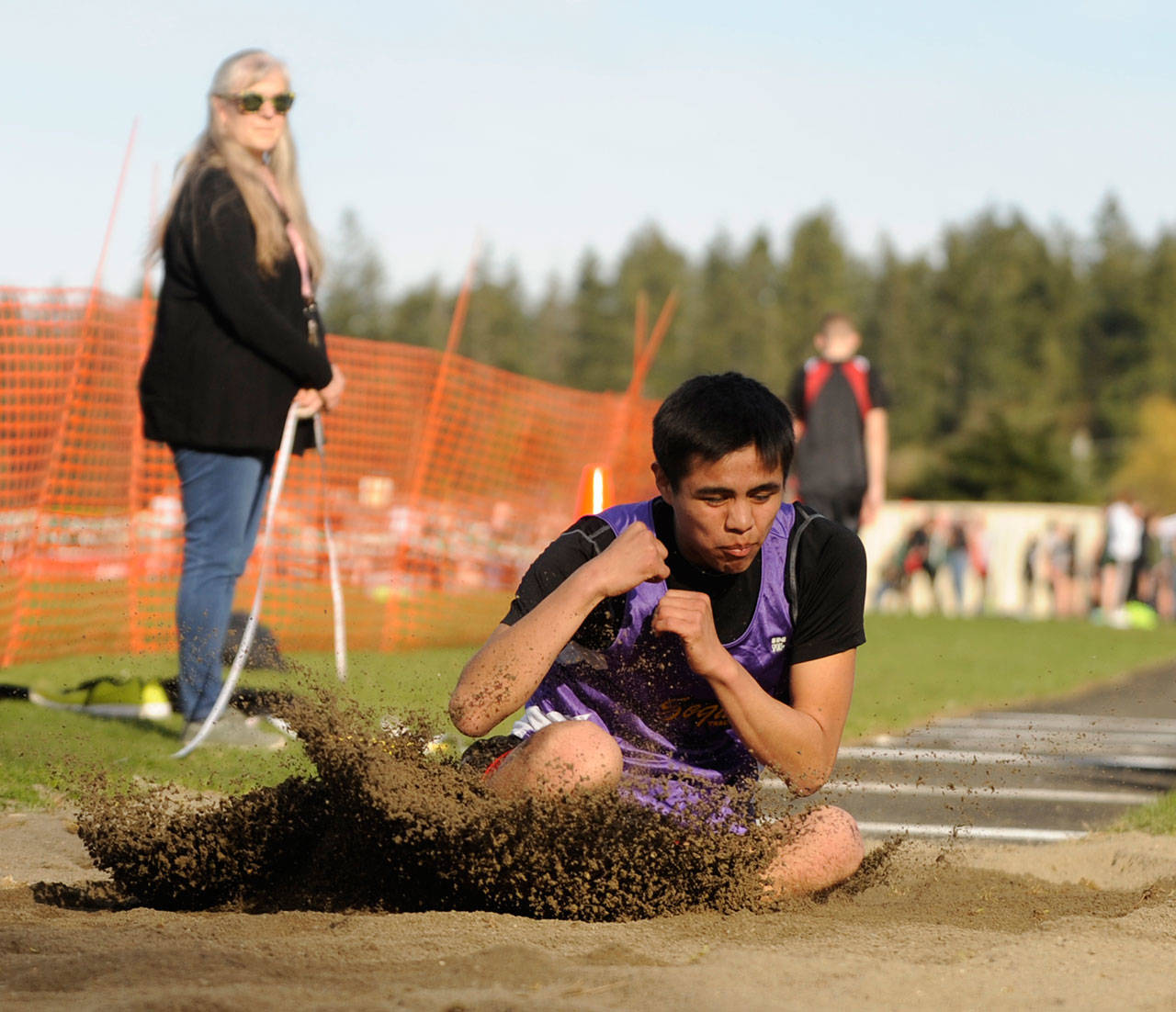 Sequim High senior Rigo Langston stretches for a solid mark in the long jump at last week’s “Flying A” meet in Port Angeles. Langston had a personal best 16-6.5 effort in the event, good for 12th overall. Sequim Gazette photo by Michael Dashiell