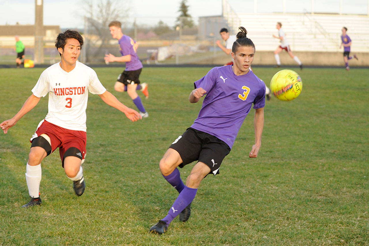 Sequim’s Ryan Tolberd, right, tracks down the ball before finding teammate Adrian Funston for a goal in the Wolves’ 4-2 win over Kingston on March 28. Kingston’s Ryuzo Kumei, left, defends the play. Sequim Gazette photo by Michael Dashiell