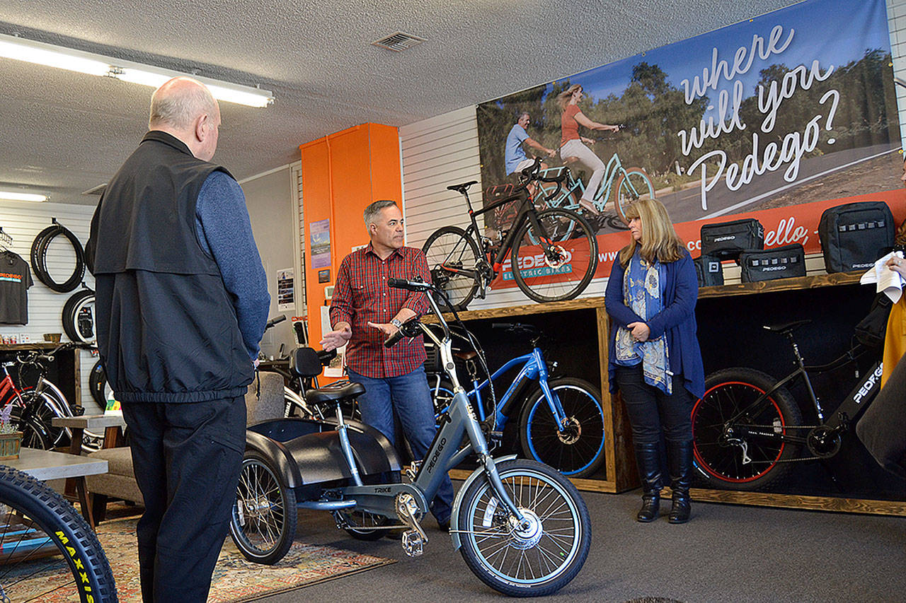 Garth Schmeck, owner of Pedego Sequim, talks with Sequim Mayor Dennis Smith and U.S. Small Business Administration Seattle District Director Kerrie Hurd on March 28 about his business and some of the challenges in the city during a walking tour as part of the Rural Strong Initiative. Sequim Gazette photos by Matthew Nash