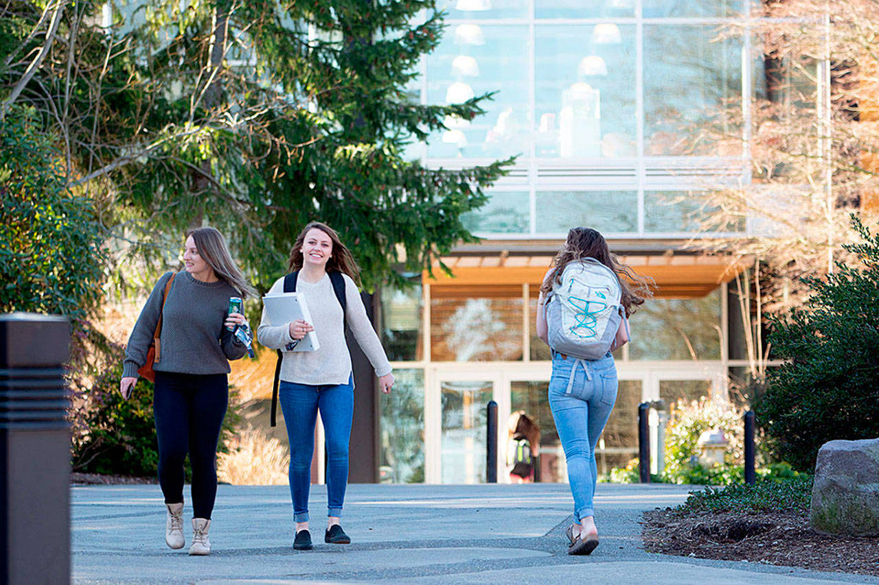 Sequim students Isabella Dennis and Bobbi Sparks walk along Peninsula Colleges campus recently. Currently, Sequim High School has 91 Running Start students attending both high school and college courses between Sequim and Port Angeles. A recent decision to cut 15 positions due to an $800,000 deficit due to shrinking enrollment may decrease the number of class offerings for college students. Photo by Jesse Major/Olympic Peninsula News Group