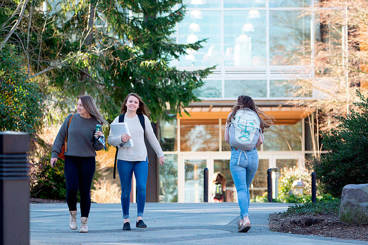 Sequim students Isabella Dennis and Bobbi Sparks walk along Peninsula College’s campus recently. Currently, Sequim High School has 91 Running Start students attending both high school and college courses between Sequim and Port Angeles. A recent decision to cut 15 positions due to an $800,000 deficit due to shrinking enrollment may decrease the number of class offerings for college students. Photo by Jesse Major/Olympic Peninsula News Group