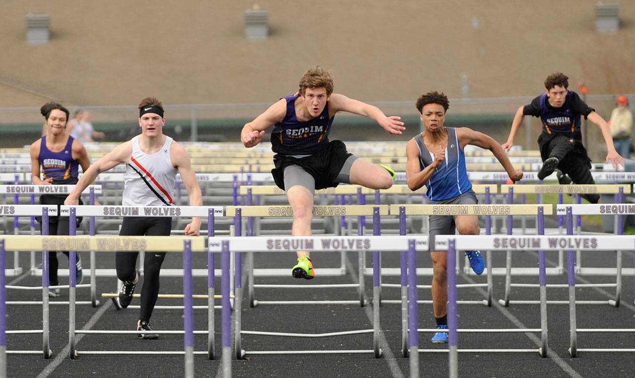 Sequim’s Fischer Jensen races to a win in the 110 high hurdles on April 11 in Sequim. Jensen also won the 300 hurdles later that day. Sequim Gazette photo by Michael Dashiell