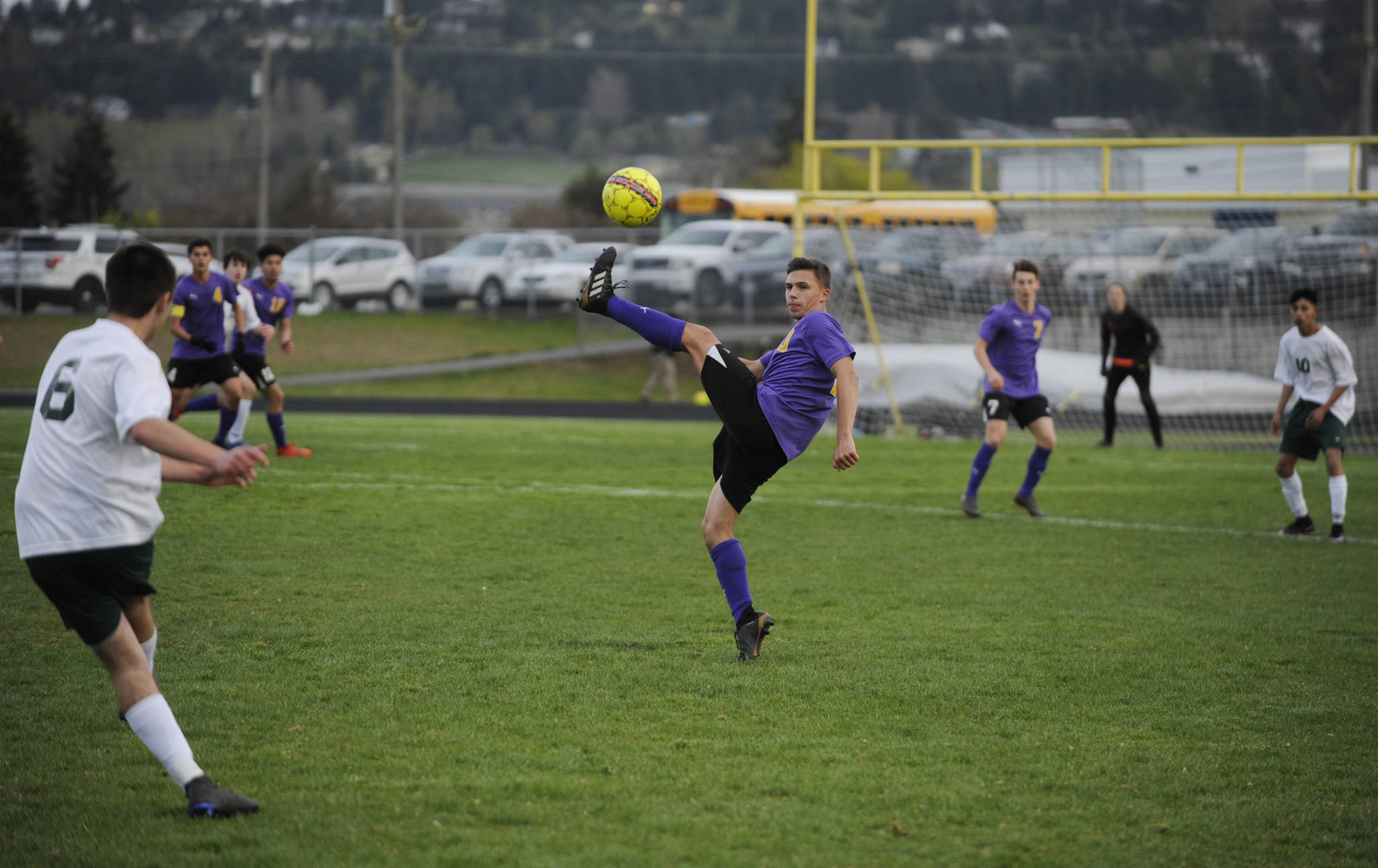 Sequim’s Mathys Tanche, center, looks to deflect a free kick from Port Angeles’ Kaleb Baier in the Wolves’ 1-0 win on April 9. Sequim Gazette photo by Michael Dashiell