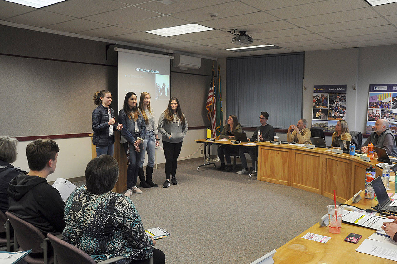 Sequim High School students (from left) Vita Olson, Erin Dwyer, Brianna Cowan and Ana Benitez talk last week with Sequim School Board directors about their experience at the HOSA (Future Health Professionals) state conference in March. Sequim Gazette photo by Michael Dashiell