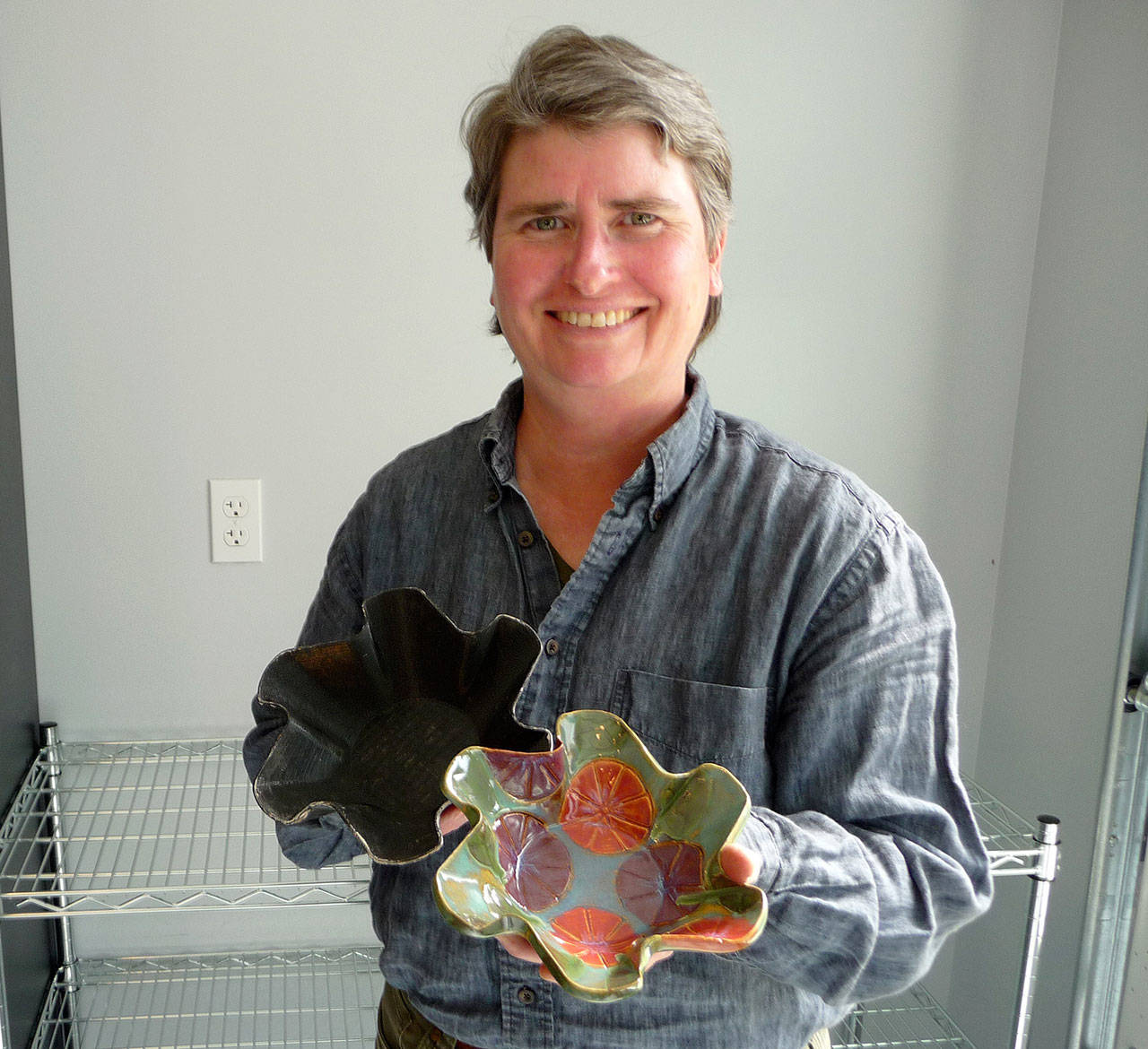 Design engineer Chris Kresa displays a mold printed by her professional 3D printer with the end result, a food-quality ceramic fan bowl. Sequim Gazette photo by Patricia Morrison Coate