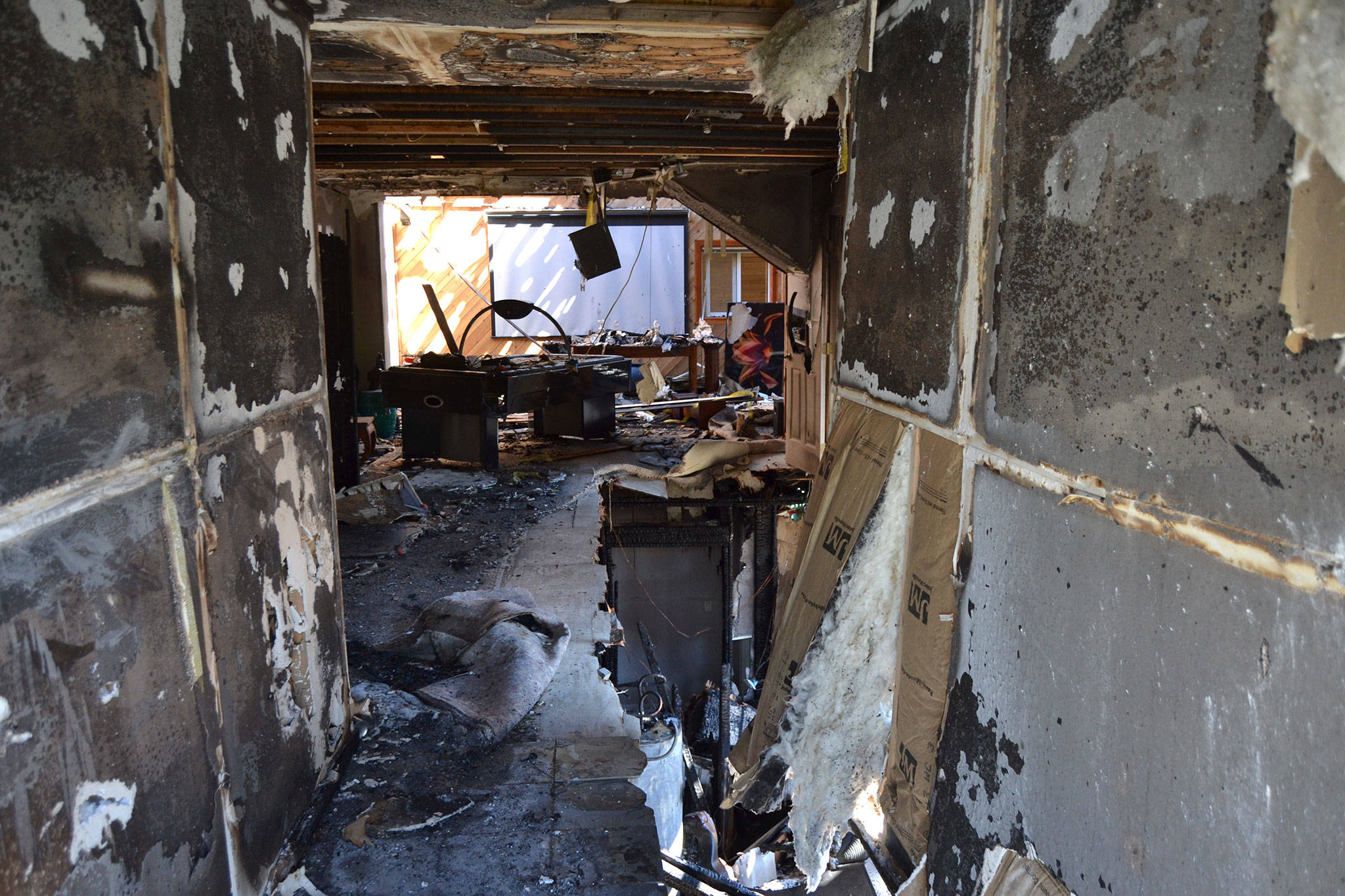 Some of the passageway into the home from this Gardiner home’s backdoor was burned from an attic fire including two bedrooms and a family room. Sequim Gazette photo by Matthew Nash