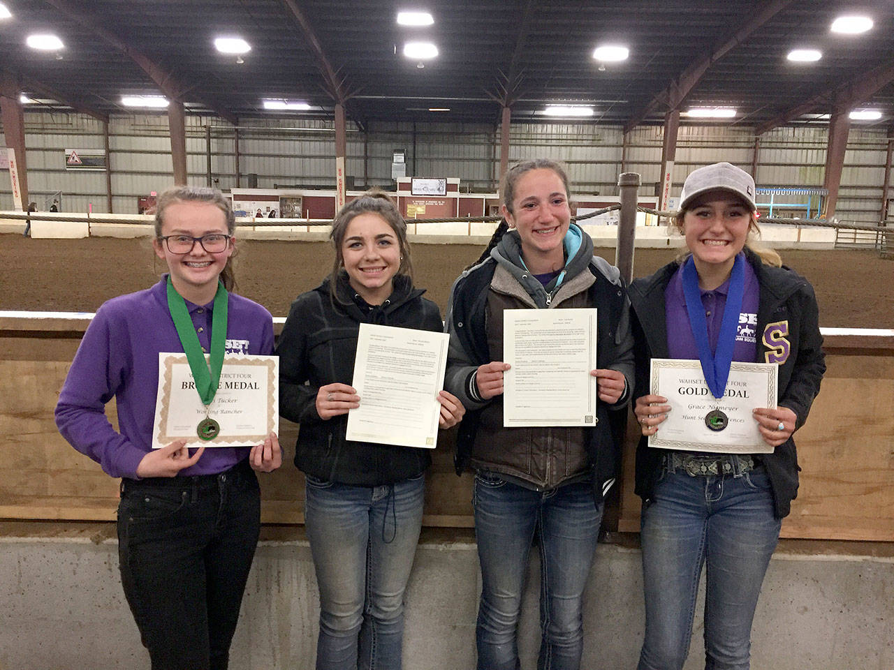 Pictured, from left, are: Keri Tucker, with her third-place bronze medal in Working Rancher; Miranda Williams and Yana Hoesel, with District 4 scholarship awards, and Grace Niemeyer, with her gold medal in Jumping. Submitted photo