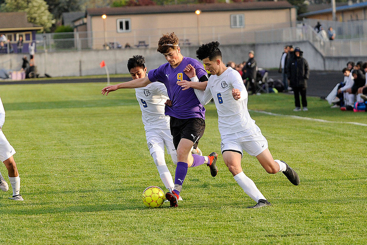 Sequim’s Adrian Funston races past North Mason players to push the tempo for Sequim on April 26. The Wolves controlled the ball for most of the game in the 7-0 win. Sequim Gazette photo by Matthew Nash
