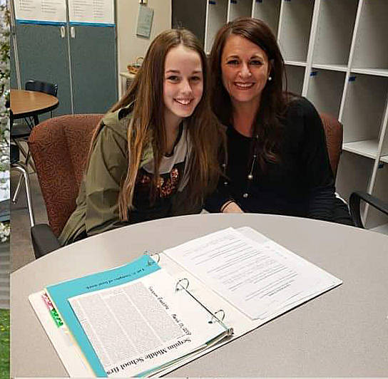 Savannah Francis, a Sequim Middle School sixth-grader, and her Wolfpack advisor, Holly Raemer, take part in recent student-led conferences. Submitted photo