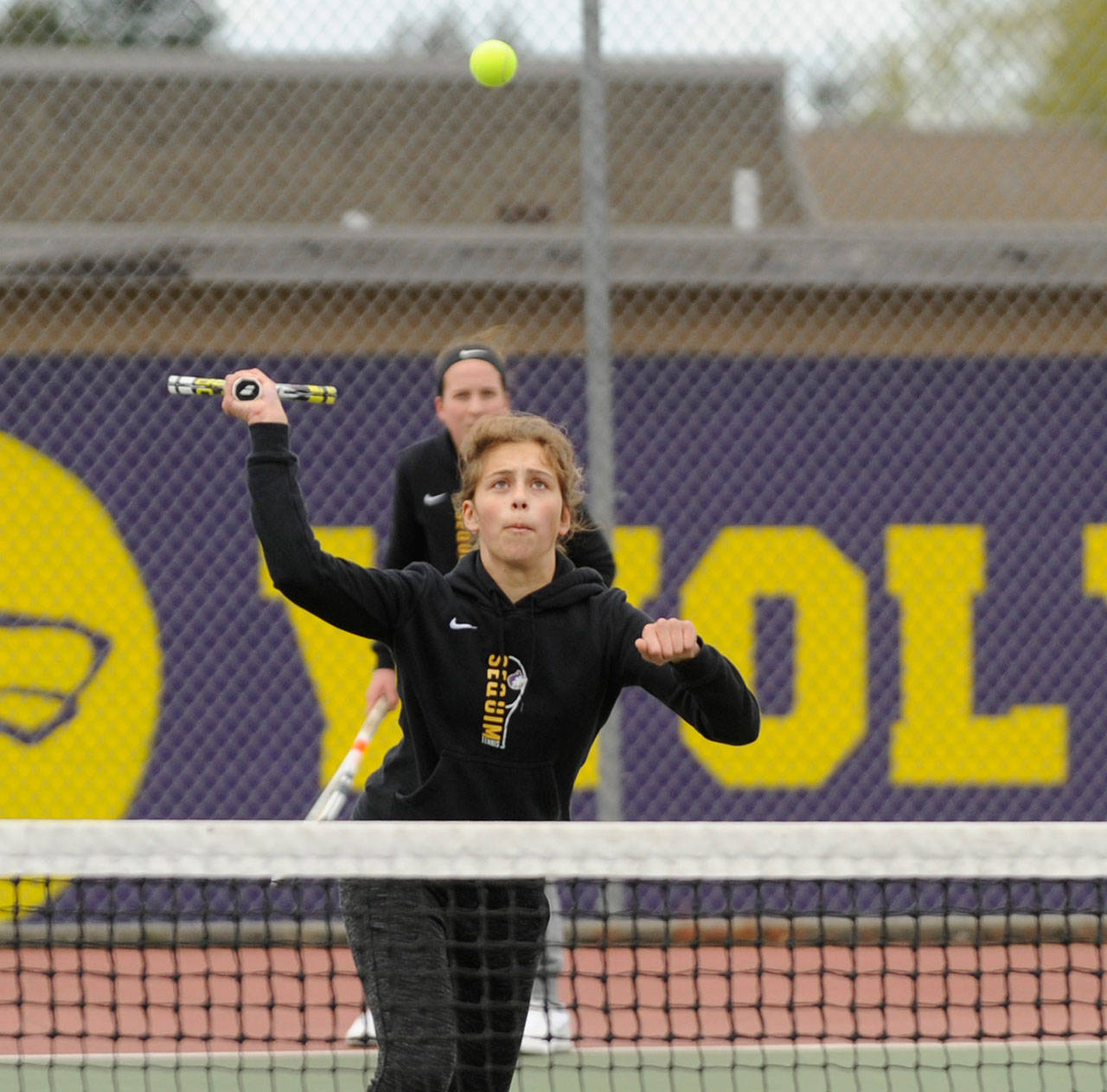 Sequim’s Jessica Dietzman, front, and Kalli Wiker knock off a North Kitsap foe in an Olympic League match on April 23. Sequim Gazette file photo by Michael Dashiell
