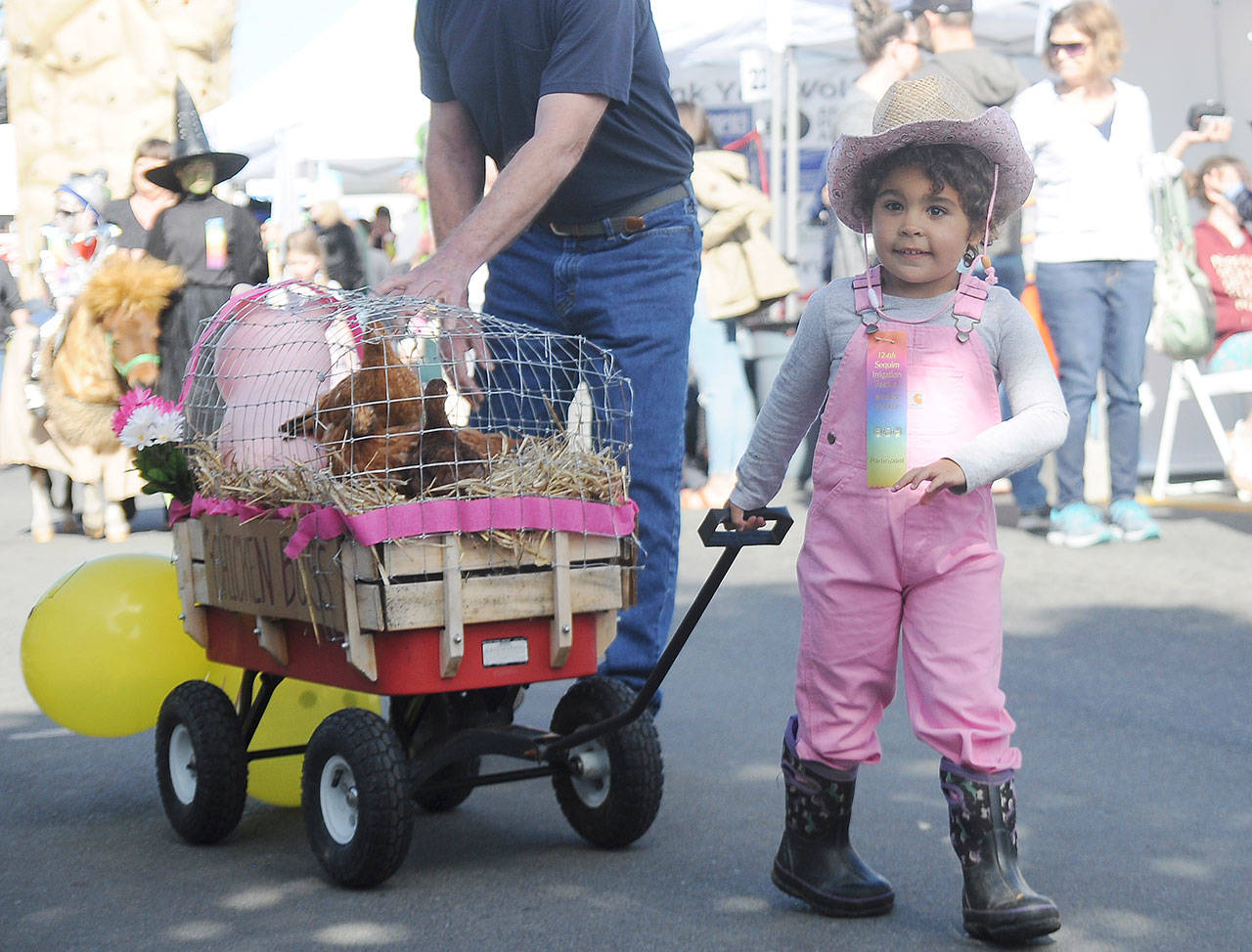 Indira Reichner, 3, of Sequim, pulls a wagon carrying chickens in the Kids Parade on May 4. The youngster took first place in the parade’s pets category. Sequim Gazette photo by Michael Dashiell