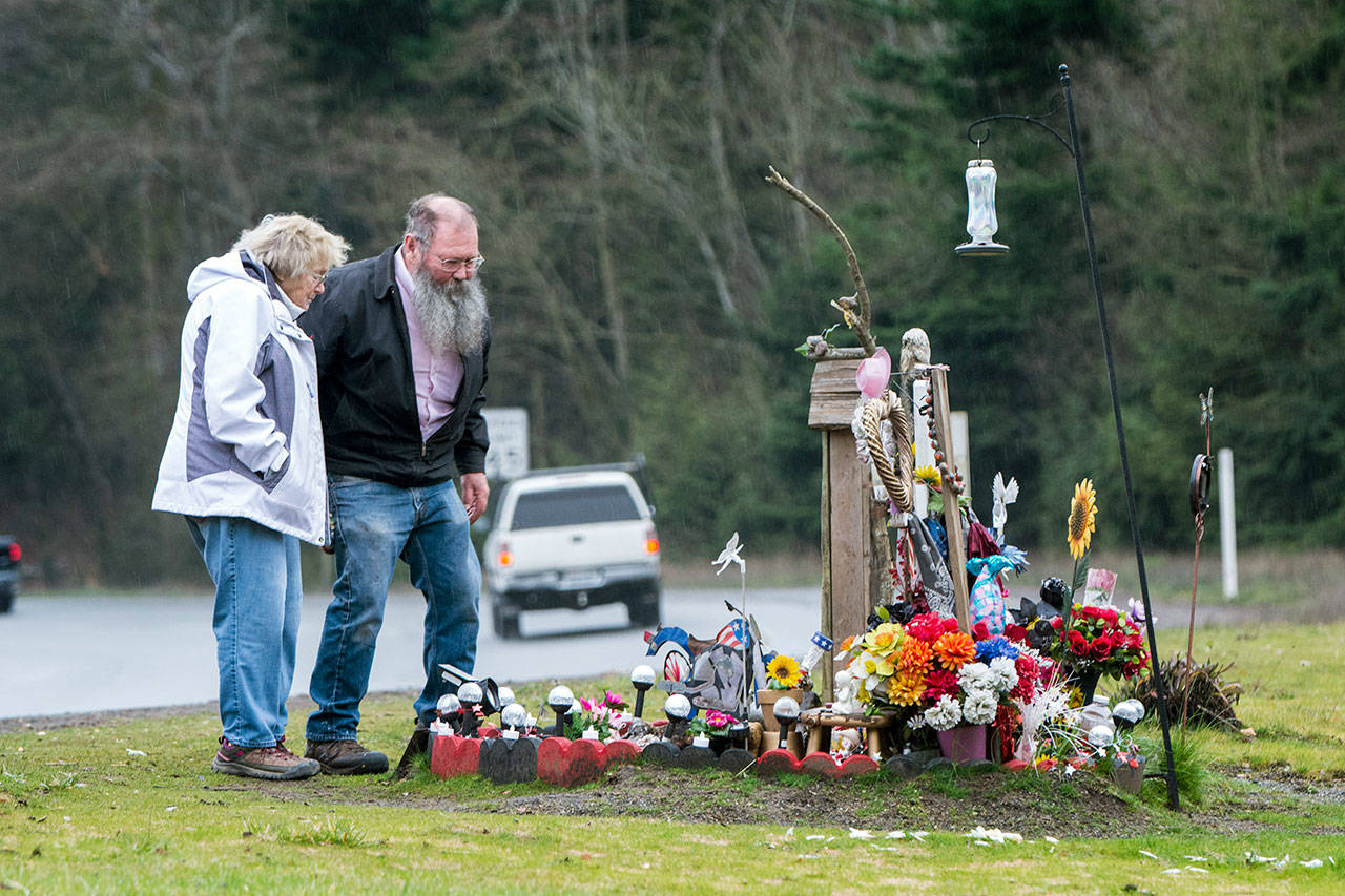 Debra and Gary Johnson visit the roadside memorial for their grandaughter Brooke Bedinger, who died in a motorcycle wreck on U.S. Highway 101 at Morse Creek on June 21. (Jesse Major/Peninsula Daily News)