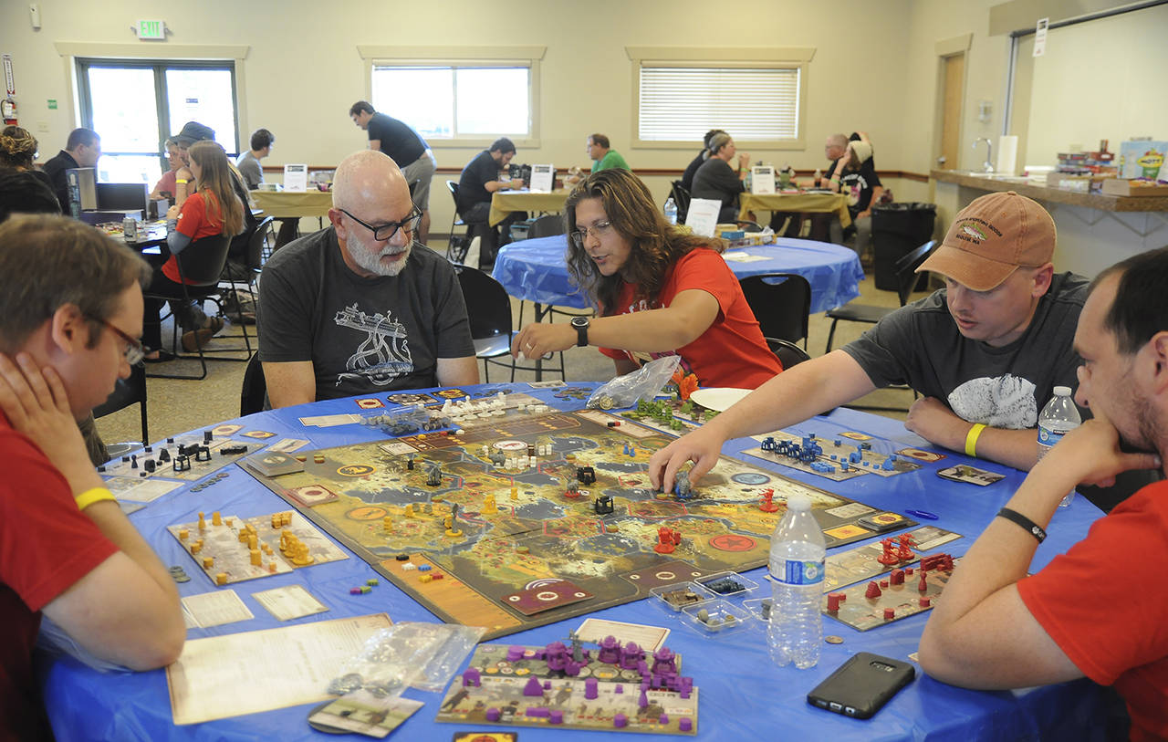 Gamers of all ages enjoying a board game session at Opttacon 2018. Sequim Gazette file photo by Michael Dashiell