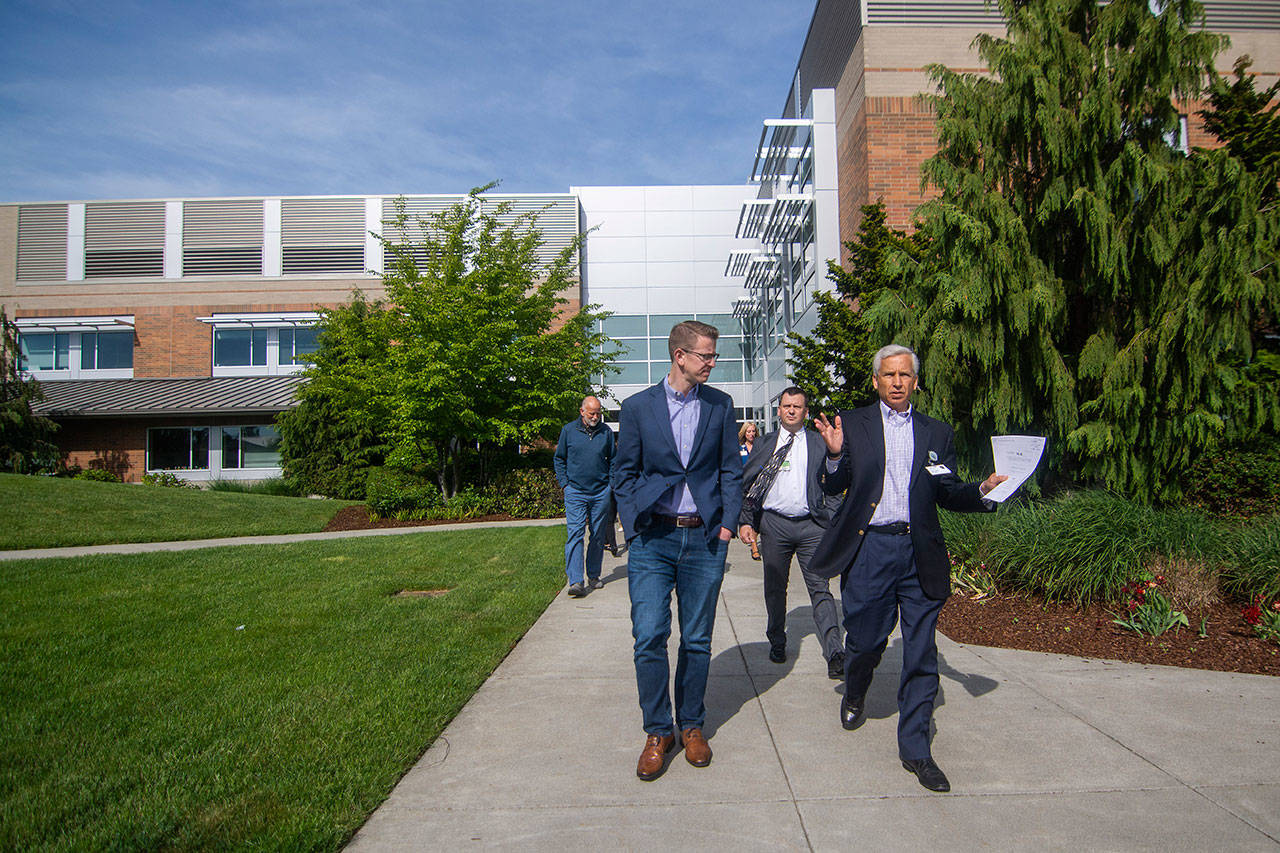 U.S. Rep. Derek Kilmer, left, and Olympic Medical Center CEO Eric Lewis walk through OMC’s Sequim Campus on Saturday. Kilmer recently introduced legislation that aims to halt a new policy from the Centers for Medicare and Medicaid Services that cuts Medicare reimbursements by up to 60 percent for multi-campus hospitals, such as OMC. Photo by Jesse Major/Peninsula Daily News