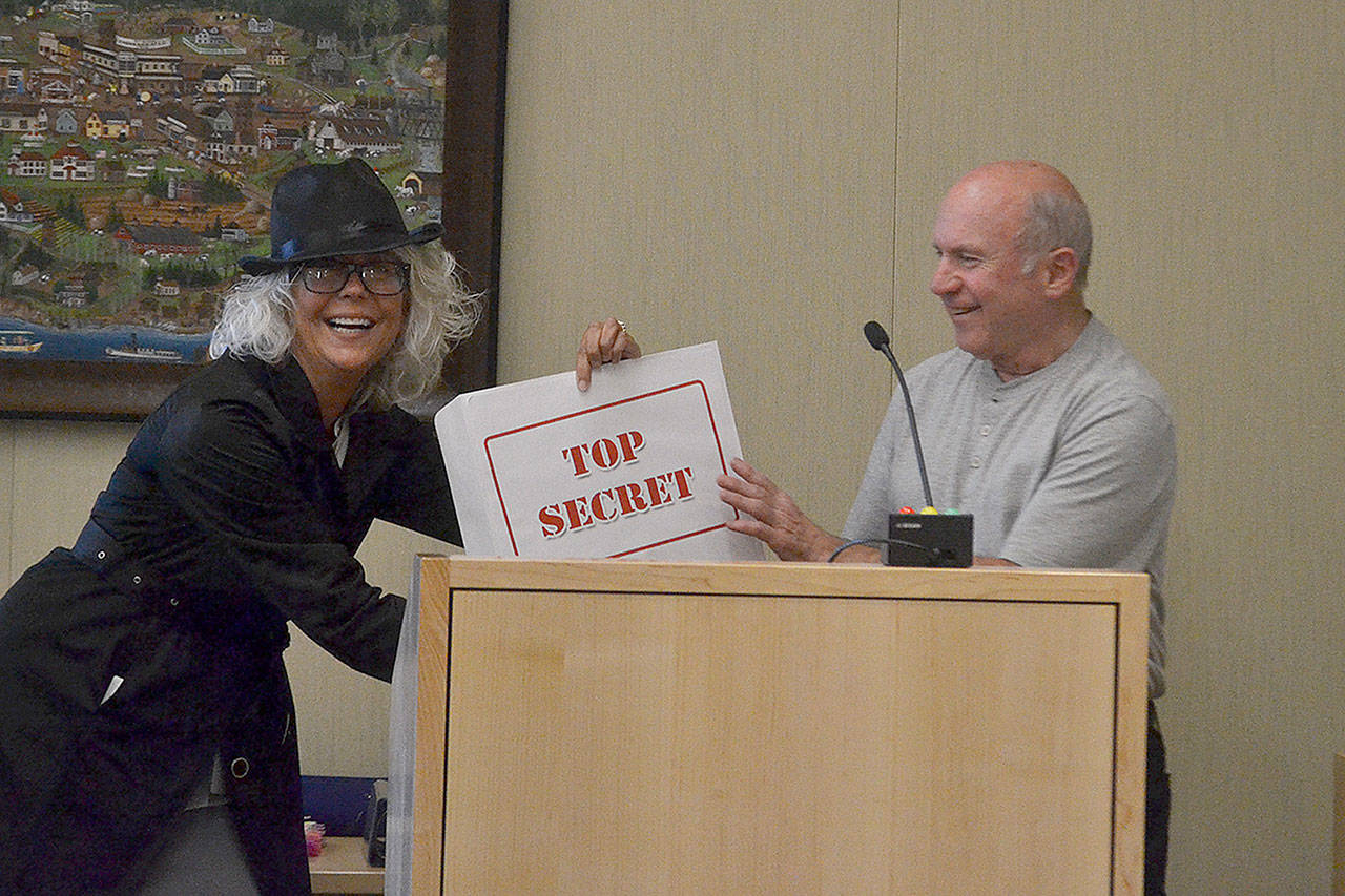 Sue Hagener, Sequim administrative services director, presents “top secret” results from The People’s Project! to Sequim Mayor Dennis Smith on May 13. This year, 951 people mostly voted for new water fountains and automated garbage cans. Sequim Gazette photo by Matthew Nash
