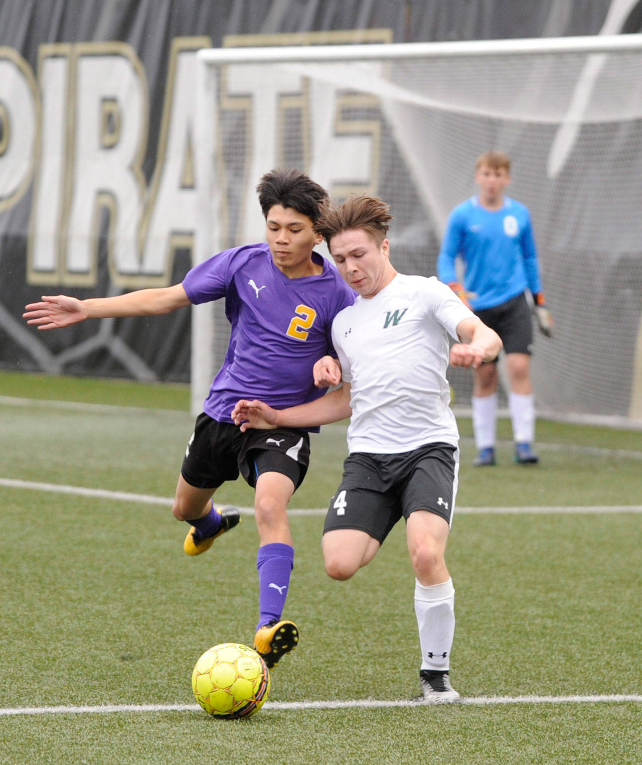 Sequim’s Kristian Mingoy, left, vies for possession with Woodland’s J.J. Fuerst in the first half of Sequim’s 3-2 state 2A tourney playoff loss on May 15. Sequim Gazette photo by Michael Dashiell