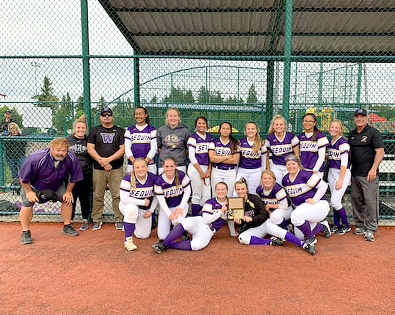 Sequim players celebrate a second-place finish at the West Central District tournament last week, going 3-1 and earning a spot in the class 2A state tournament. Submitted photo