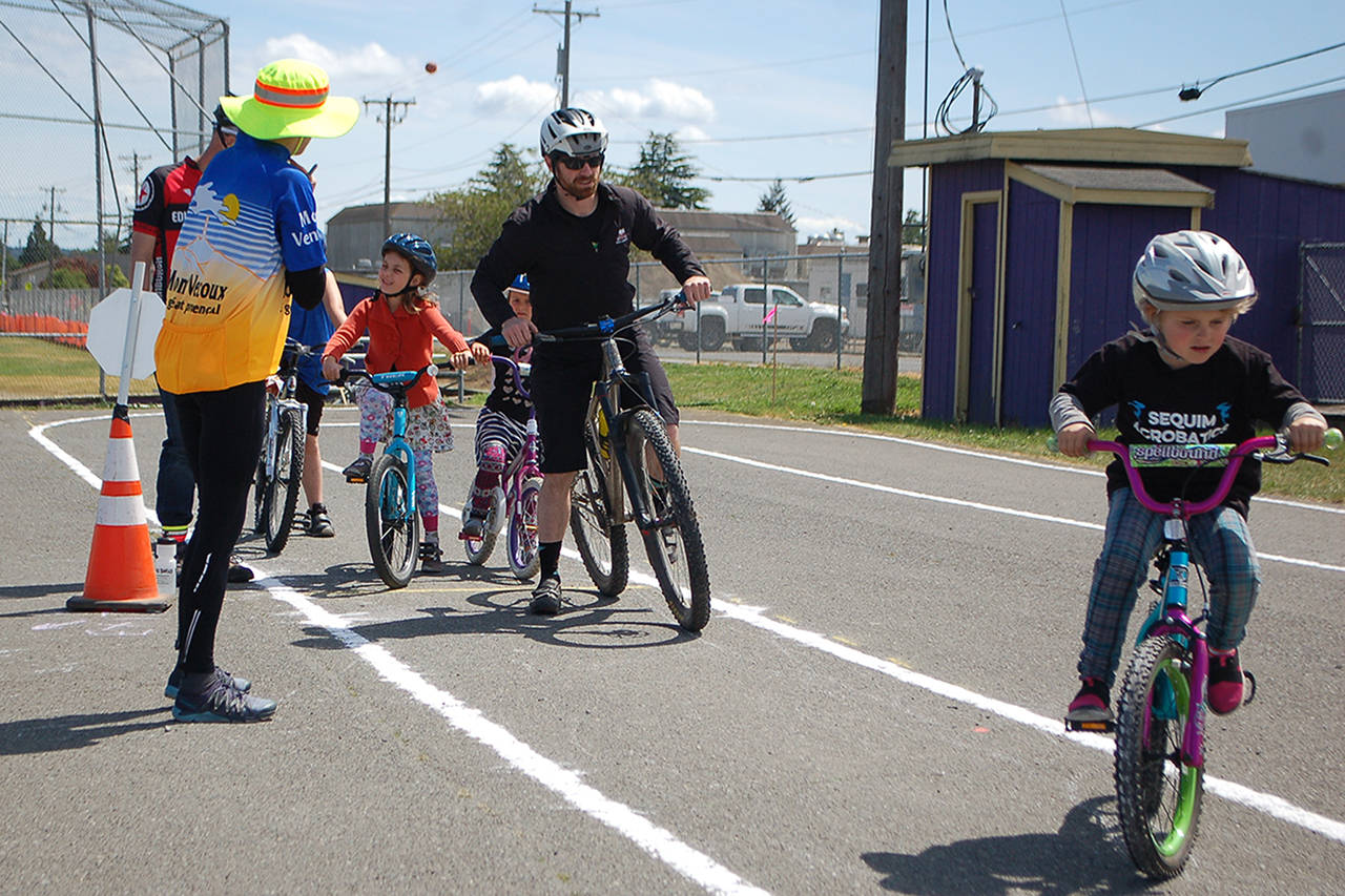 Several students are given instruction on a riding stability course at the Olympic Peninsula Bicycle Alliance’s Bike Rodeo in May 18. Sequim Gazette photo by Conor Dowley