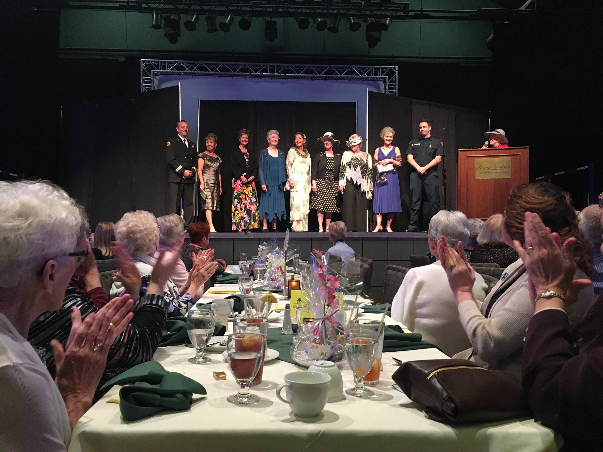 Participants of the Sequim-Dungeness Hospital Guild’s fashion show on May 23 stand together at its finale. Participants included, from left, Captain Derrell Sharp with Clallam County Fire District 3, Vicki Boyer, Jeanne Berger, Sue Cram, Elly Wilson, Wanda Bean, Dianne McIntosh, Mary Nesbitt, and firefighter/paramedic Casey Sires, along with fashion show announcer Thelma Sullock. Sequim Gazette photo by Matthew Nash