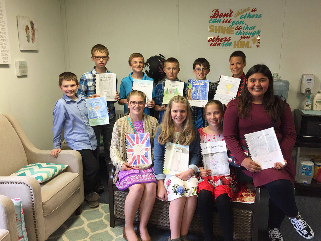Students at Olympic Christian School sixth-graders celebrate their writings at the school’s recent Young Authors festival. Pictured are (back row, from left) Liam Critchlow, Caleb Lagrange, Luke Flodstrom, Caleb Crawford, Timothy VanProyen and Andrew Brown, with (front row, from left) Sammy Smith, Lauren Smith, Abby Jones and Nalani Zavala. Submitted photo