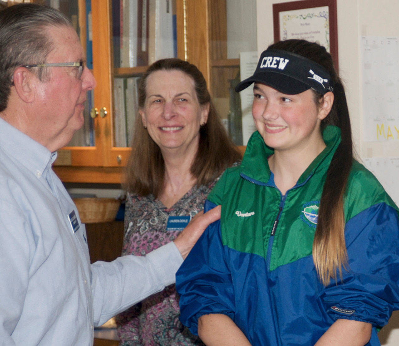 Sequim Bay Yacht Club members are helping Port Angeles rower Ella Ventura, right, defray her expenses for this summer’s US Rowing Under 17 Olympic Development Program, presenting her with a donation on May 24. Presenting a check for $625 on May 24 were, from left, yacht club commodore Doug Schwarz and master rower Lauren Doyle. Submitted photo