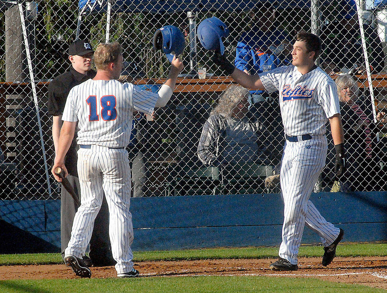 Lefties third baseman Evan Hurn, right, is greeted by fellow baserunner Alexander Marco at home plate after Hurn’s two-run homer in the second inning at Port Angeles’ Civic Field on June 7. Photo by Keith Thorpe/Peninsula Daily News